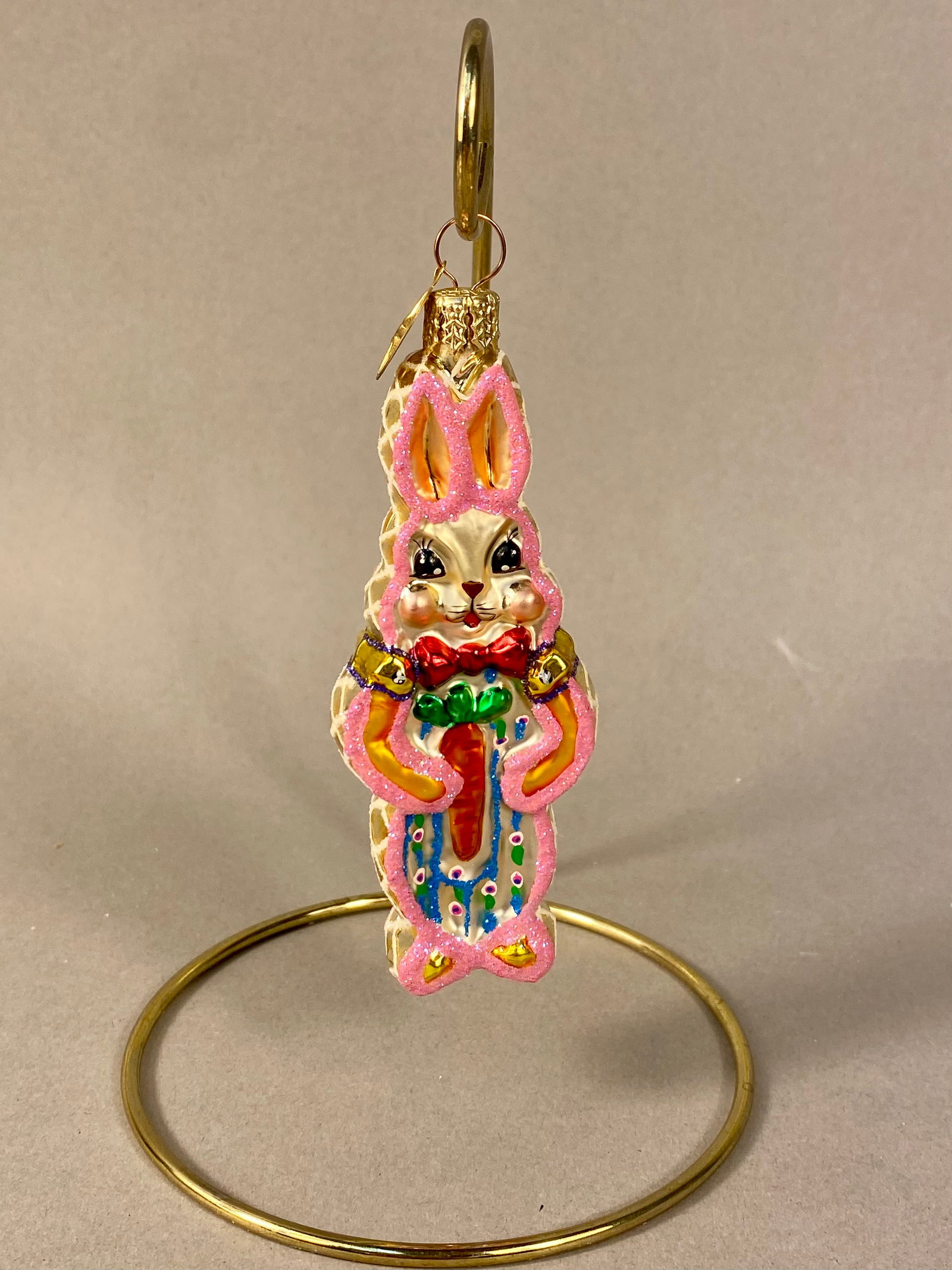 Christopher Radko Billy Bunny Mouth-Blown Glass Holiday Ornament: This mouth-blown glass holiday ornament is produced by Christopher Radko and depicts a standing rabbit, identified as Billy Bunny, holding a carrot. The figure is crafted from silvered glass with a ch