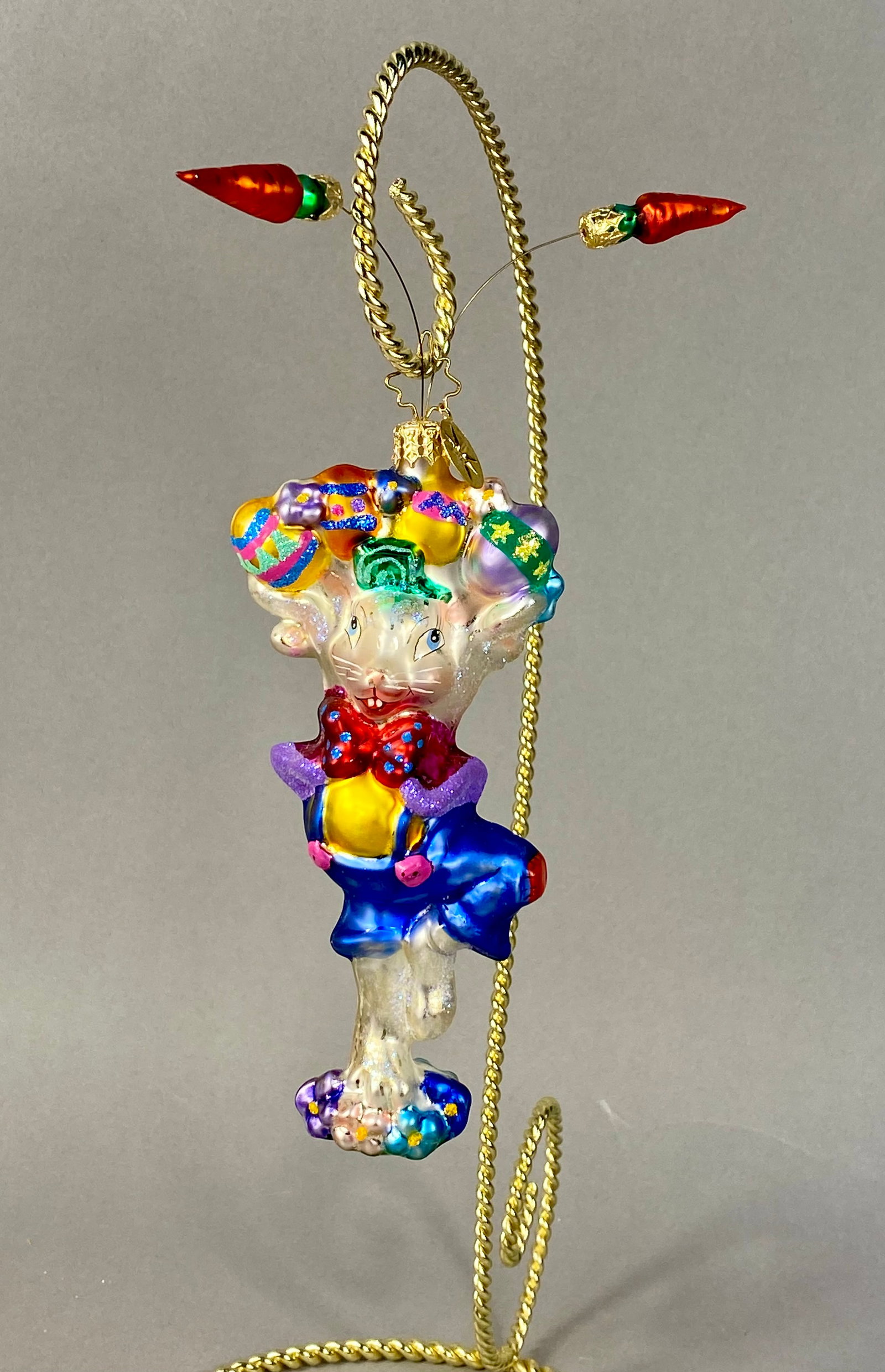 Christopher Radko Peter P. Cottontail Hand-Blown Glass Easter Ornament: This is a handcrafted, mouth-blown glass ornament from Christopher Radko, identified as Peter P. Cottontail (Model 1011346). The ornament depicts a personified Easter bunny in a dynamic, joyful pose. 
