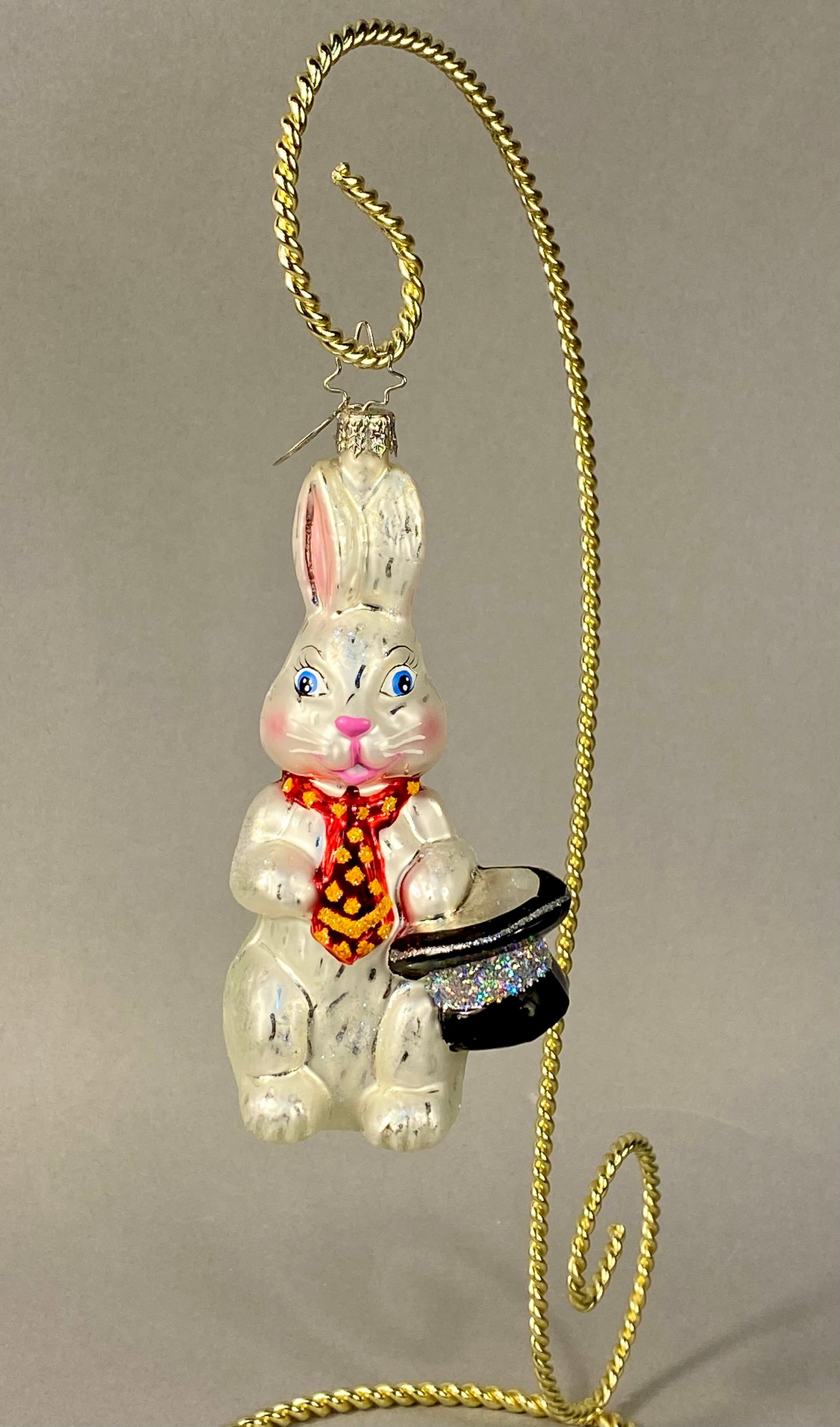 Christopher Radko Billy Bunny Hand-Blown Glass Christmas Ornament: A hand-blown glass Christmas ornament by Christopher Radko, featuring an anthropomorphic white rabbit. The standing figure has a pearlescent finish and hand-painted details, including blue eyes, pink 