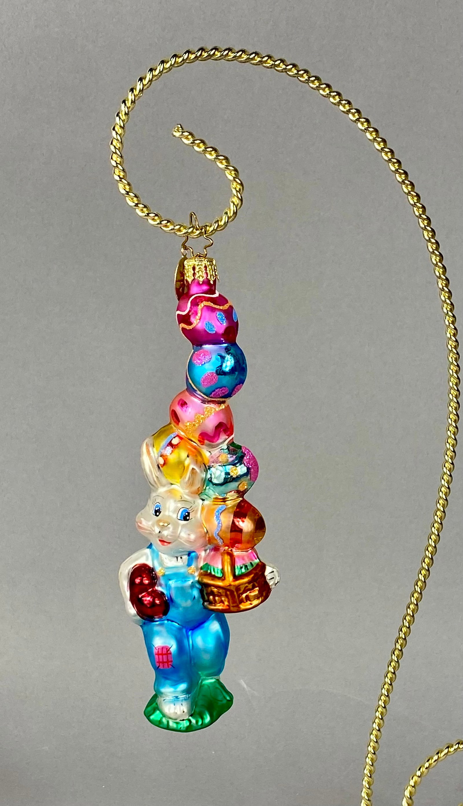 Christopher Radko Billy Bunny Goes Shopping Glass Ornament: Christopher Radko hand-painted blown glass ornament titled Billy Bunny Goes Shopping. The piece depicts a white rabbit wearing light blue overalls with a pink patch, holding a red heart in its right h