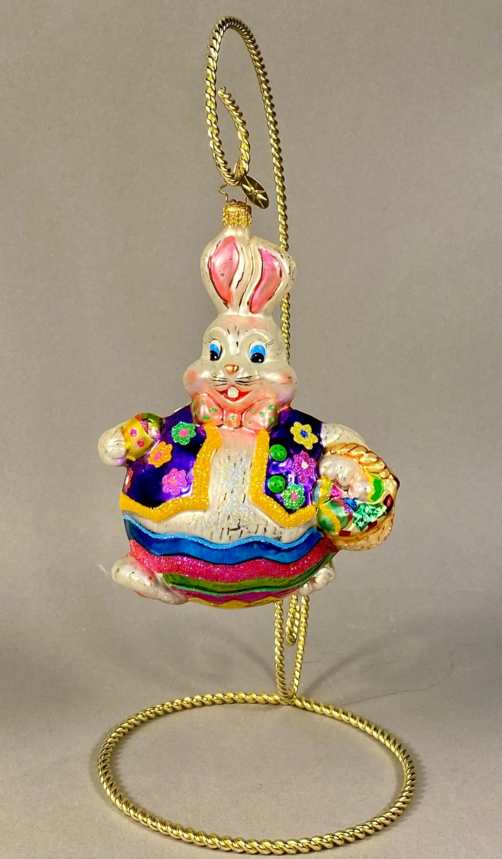 Christopher Radko Billy Bunny Goes Shopping Glass Easter Ornament: A hand-blown glass holiday ornament produced by Christopher Radko, titled Billy Bunny Goes Shopping. The ornament depicts an anthropomorphic rabbit character in a standing pose. The figure is dressed 