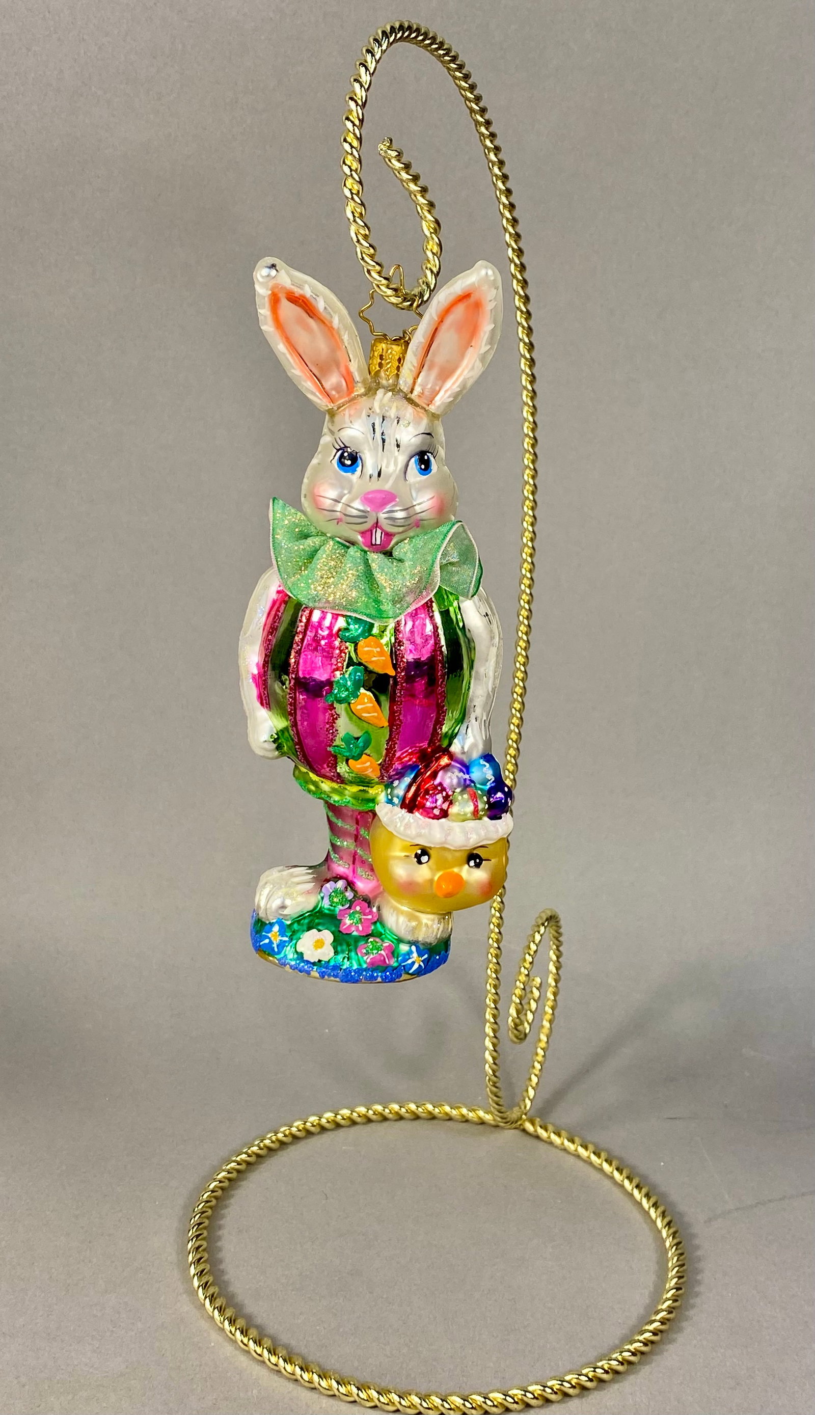 Christopher Radko Triple Treasure Easter Bunny Glass Ornament: A mouth-blown and hand-painted glass Easter ornament produced by Christopher Radko, specifically identified as the Triple Treasure model. The figure depicts an anthropomorphic white rabbit with blue e