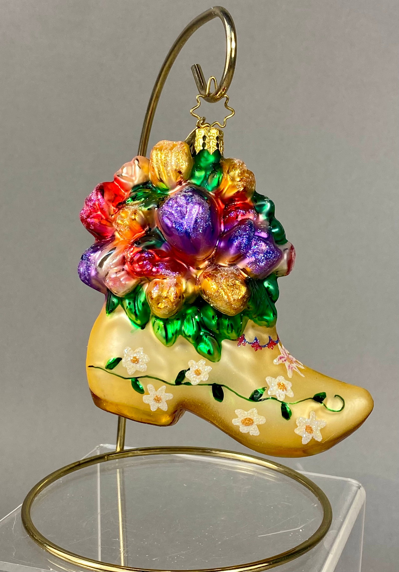 Christopher Radko Hand-Blown Glass Floral Dutch Clog Christmas Ornament: This hand-blown glass Christmas ornament is produced by Christopher Radko, identified by the signature six-pointed star-shaped wire hanger and the gold-toned circular metal charm featuring a sunburst 
