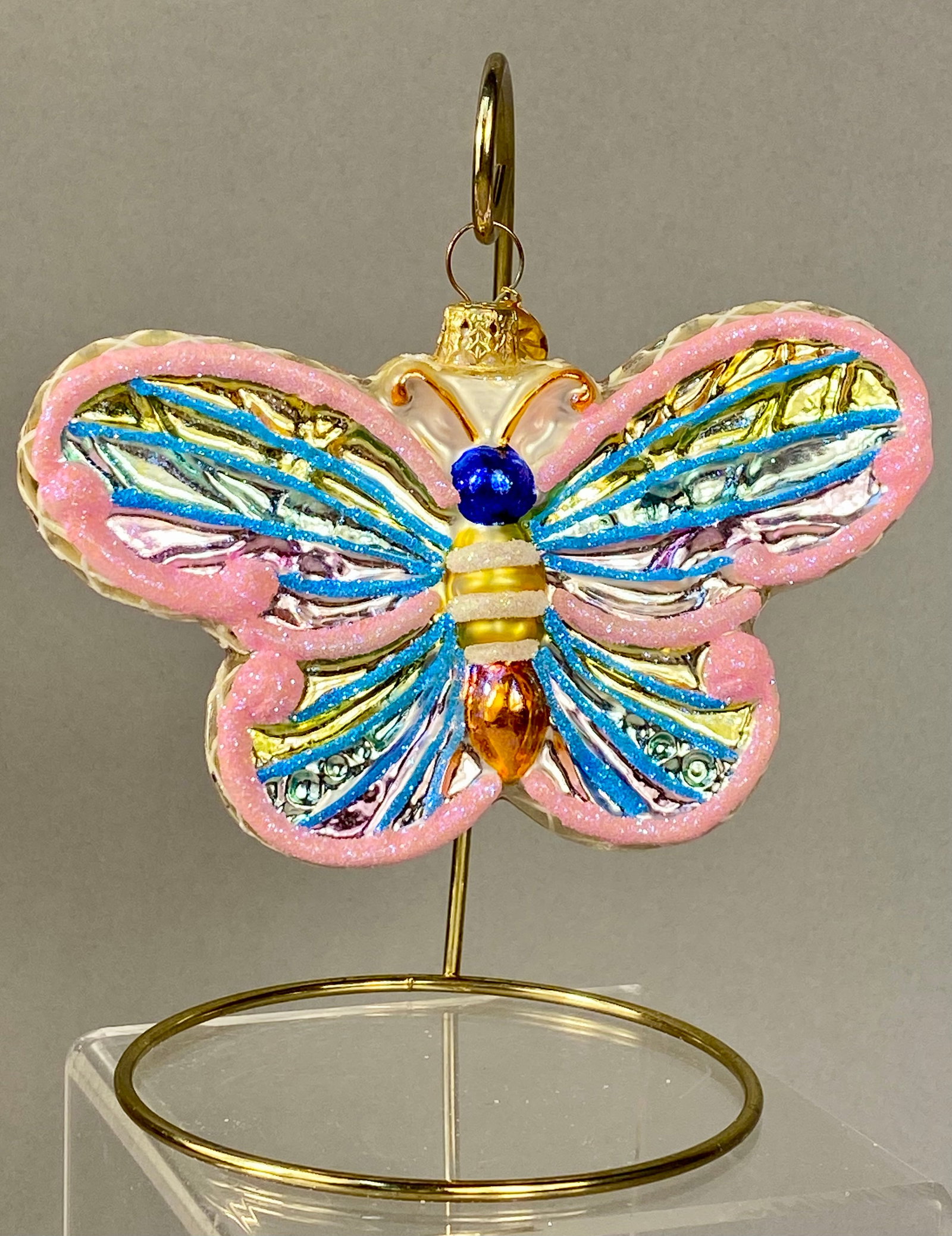 Christopher Radko Butterfly Glass Christmas Ornament: This is a mouth-blown glass Christmas ornament in the form of a butterfly, produced by Christopher Radko. The ornament is crafted from mold-blown, silvered glass and features vibrant hand-painted deta