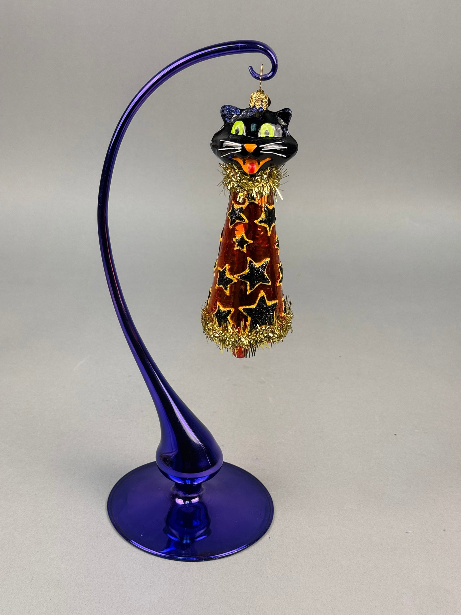 Radko Black Cat Magic Halloween Glass Bell Ornament: This is a hand-blown glass Halloween ornament from Christopher Radko, identified as the Black Cat Magic pattern. The ornament is fitted with the signature Christopher Radko star-shaped gold-toned meta