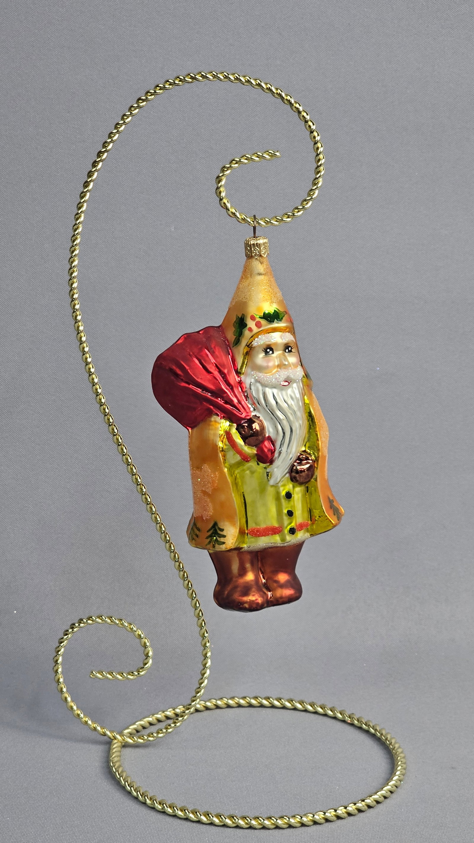 Christopher Radko Little Golden Hood Santa Glass Christmas Ornament with Stand: Christopher Radko Little Golden Hood special event Santa Claus ornament, produced by Inge-Glas. This hand-blown glass ornament features Father Christmas wearing a tall, pointed hood and a long robe in
