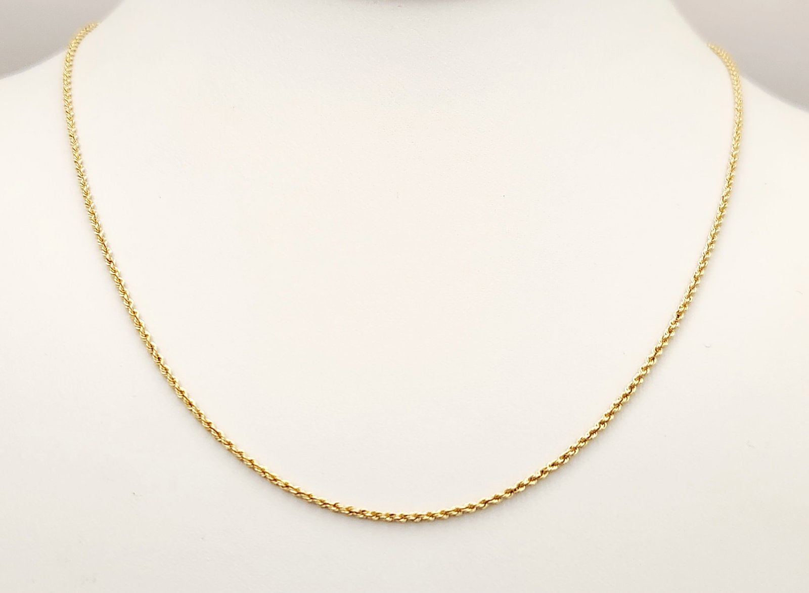 14K Gold Rope Necklace 1.2 Grams: This 14 karat yellow gold necklace features a twisted rope link design and is secured with a spring ring clasp. Weight: 1.2 grams Length: Approximately 20 inches. The chain is in good condition with n