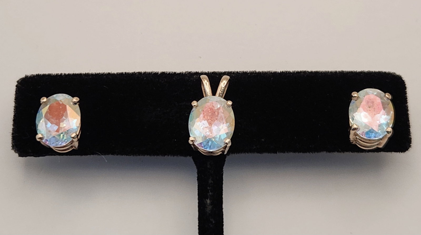 14K Rainbow Moonstone Jewelry 3.7 Grams: This jewelry suite comprises a pendant and a pair of stud earrings. Earring backs 14K markings. Pendant length: approximately 1/2 inch Earring head length: approximately 5/16 inch Weight: 3.7 grams. T