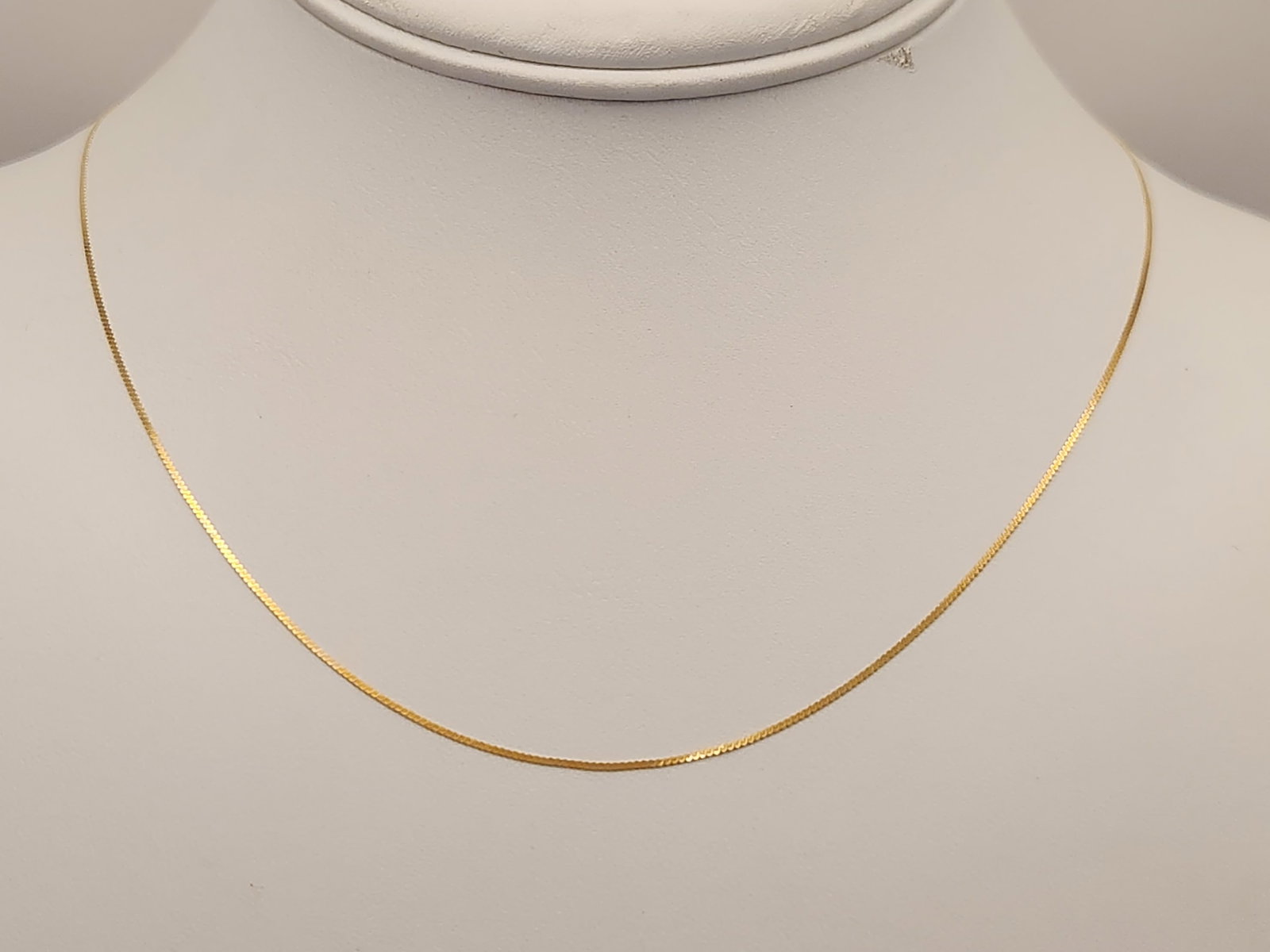 14K Serpentine Necklace 1 Grams: A fine 14 karat yellow gold serpentine link chain necklace weighing approximately 1.0 gram featuring a spring ring clasp and marked Italy. Necklace is 18". Good condition.