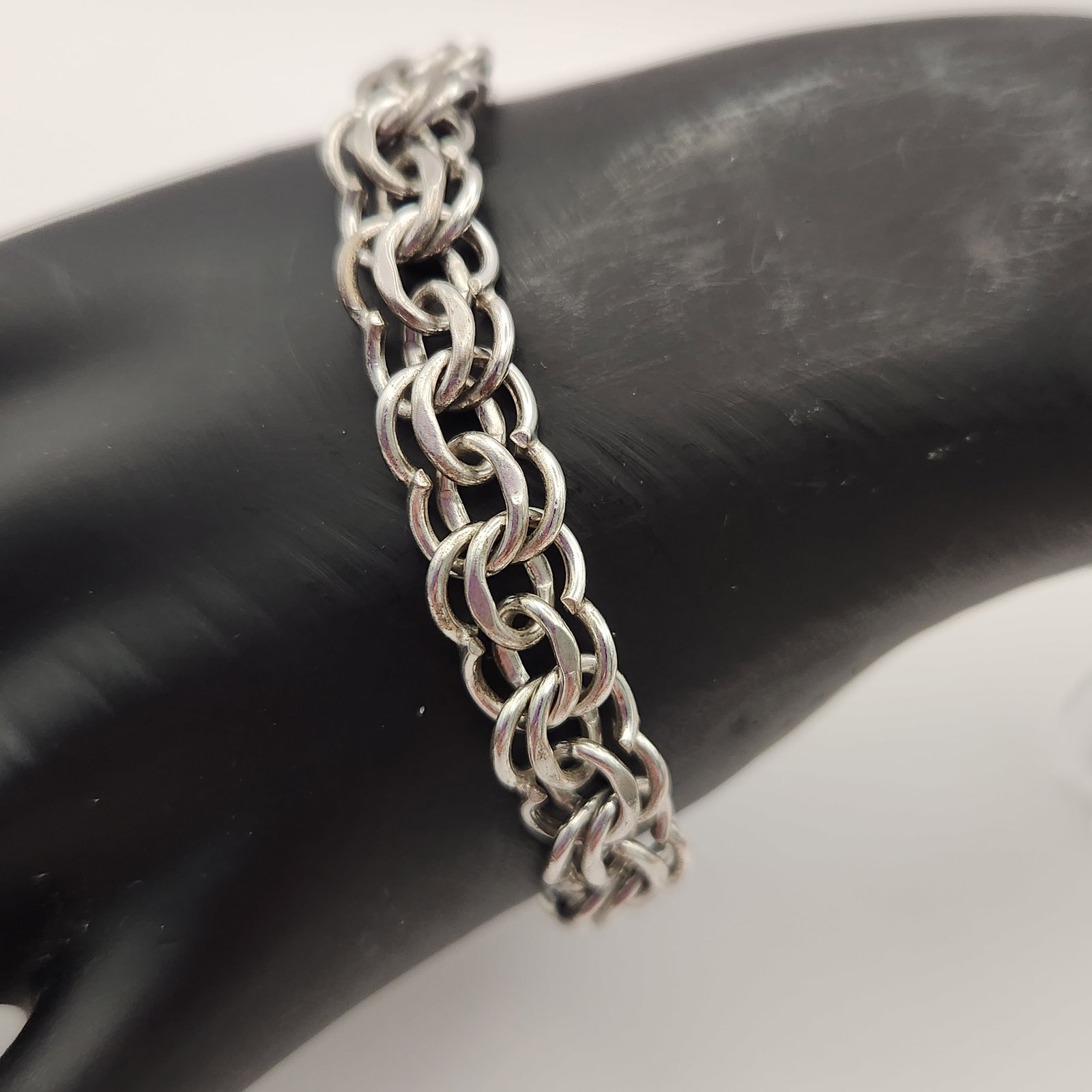 Elco Sterling Triple Link Bracelet 23 Grams: This vintage sterling silver bracelet features a triple-interlocking link design. The underside of the clasp is stamped with the maker's mark Elco in cursive script and the purity mark STERLING in
