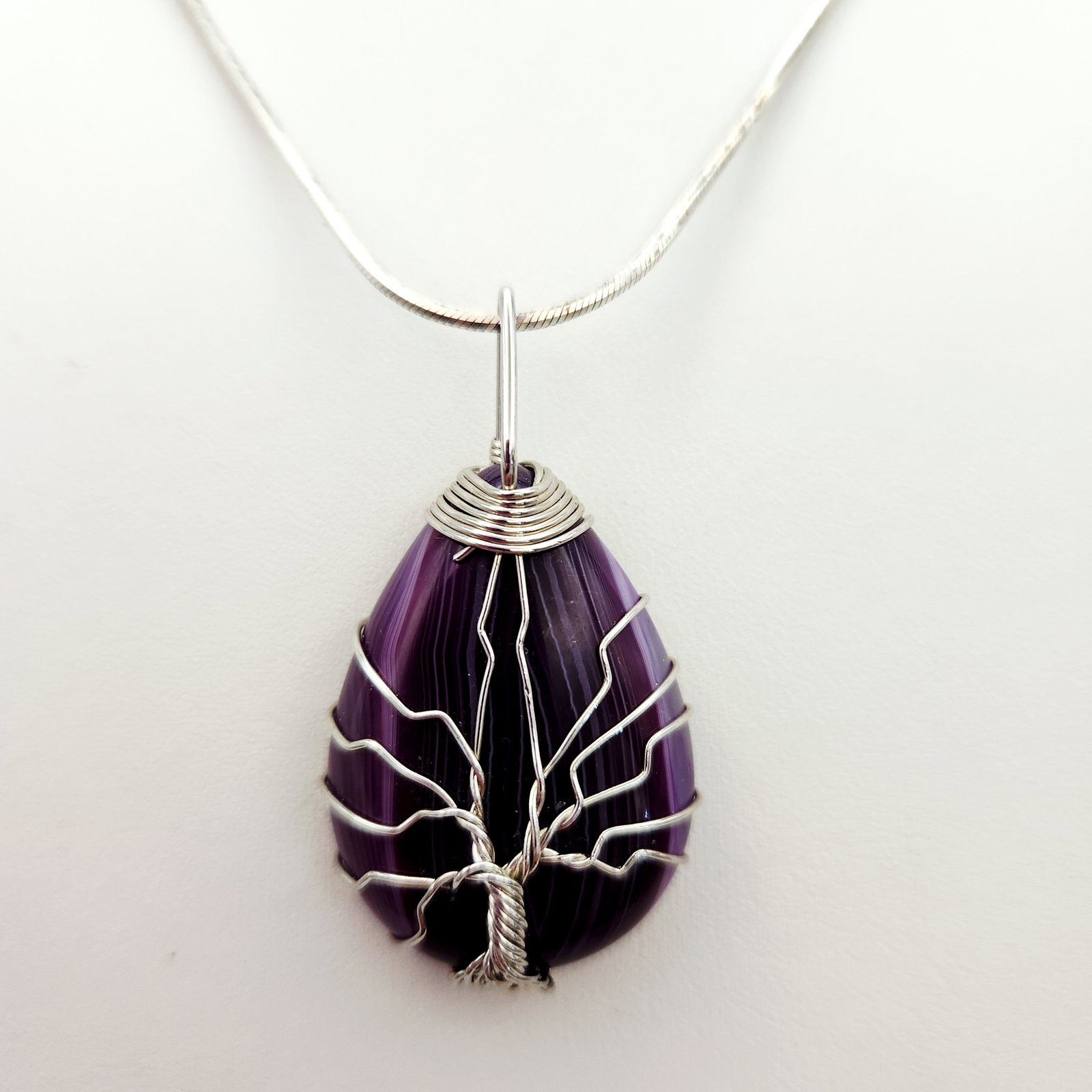 Sterling Tree of Life Necklace 19.3 Grams: This necklace consists of a sterling silver snake chain and a teardrop-shaped purple banded agate pendant. Necklace is 24" Chain weight: Approximately 7.9 grams Total weight: Approximately 19.3