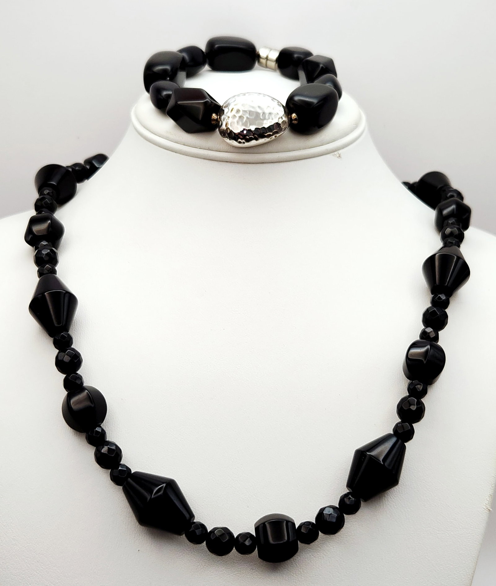 Black Quartz Beaded Sterling Jewelry: This jewelry set consists of a Desert Rose Trading necklace and a Silpada bracelet. The necklace's clasp is stamped DTR 925 CHINA, indicating sterling silver. The bracelet incorporates a large,