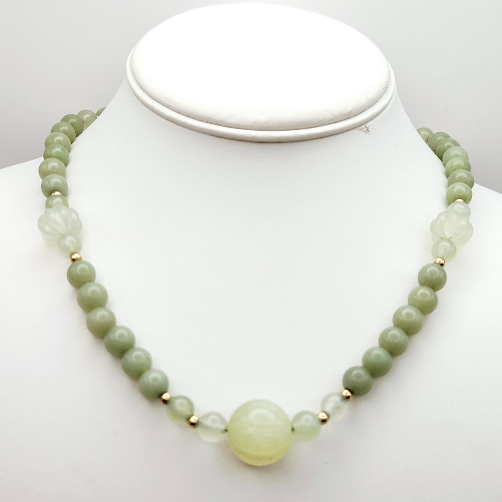 Green Jade Stone Necklace Vermeil Clasp: This vintage necklace is composed of graduated multi-shades of green jade beads. The reverse of the clasp is stamped with the mark SILVER, indicating Vermeil. Length: 17 inches. The necklace is in goo