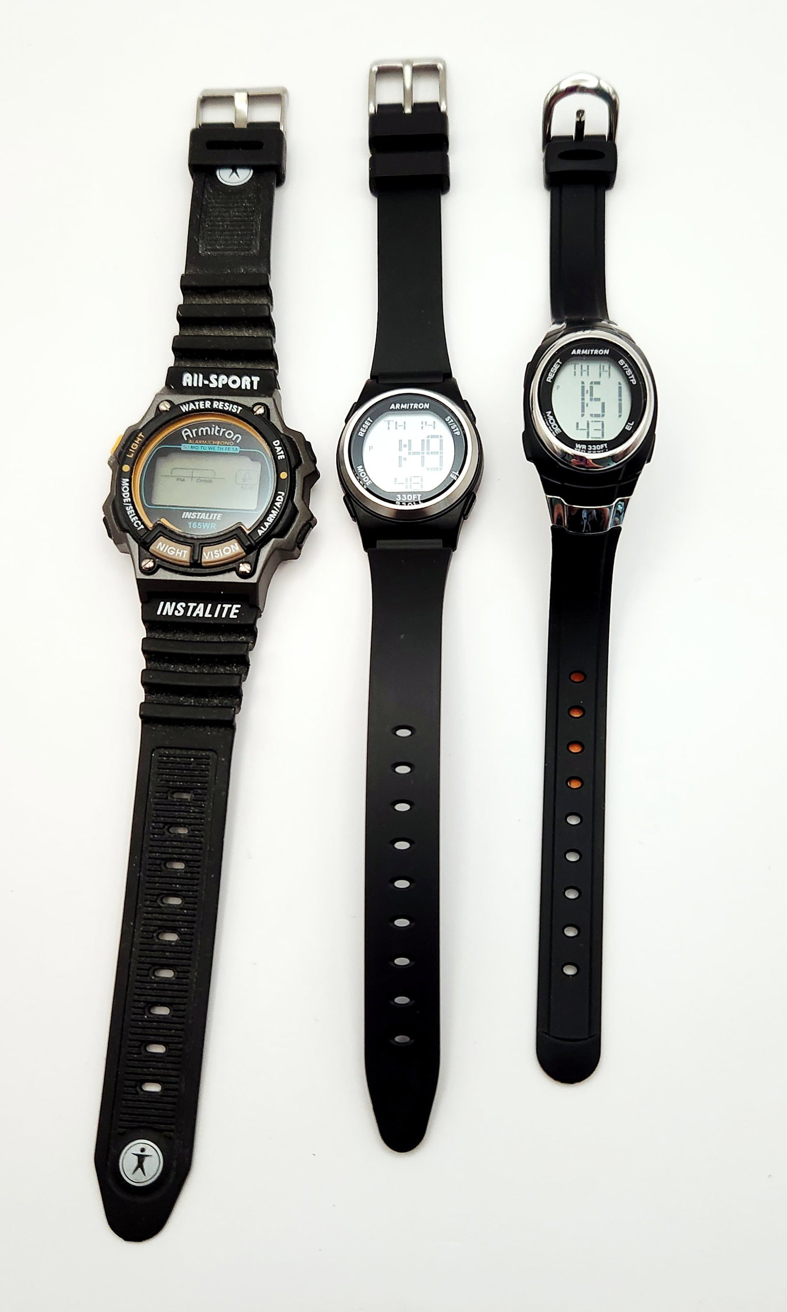 A Trio of Armitron Digital Sports Wristwatches: The group includes one All-Sport model with Instalite technology, water-resistant to 165 feet. Its stainless steel case back is marked M112 and 40/6595. The collection also includes two smaller models