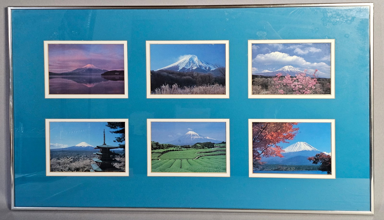 Framed Photograph Collection Featuring Views of Mount Fuji: A collection of six photographs showcasing iconic perspectives of Mount Fuji, Japan. 16.5 x 28 inches (frame). The photographs appear to be in good condition with no visible signs of fading or moistur