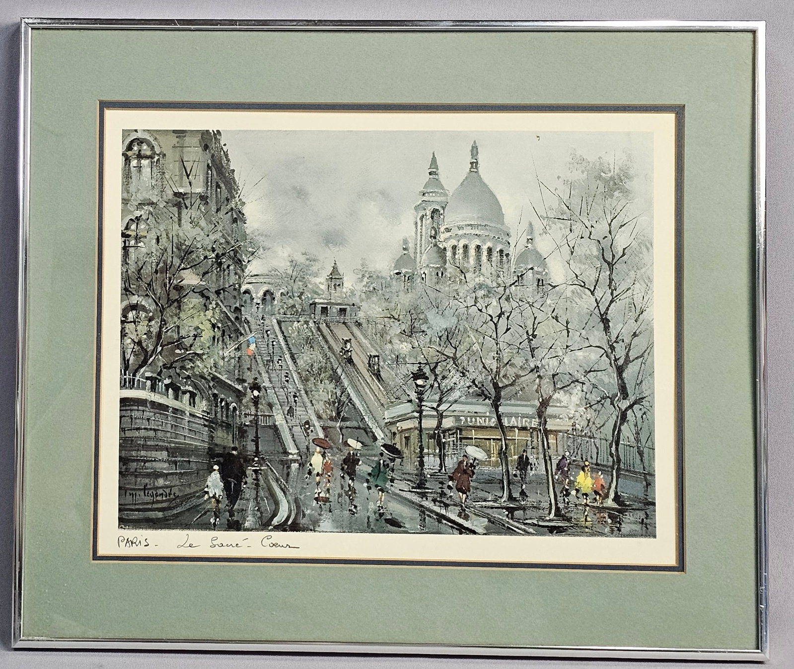 Maurice Legendre Framed Print Paris Le Sacre-Coeur: This framed print is a photomechanical reproduction or offset lithograph after the original work by the artist Maurice Legendre (French, b. 1910). The composition depicts a bustling scene in the Montm