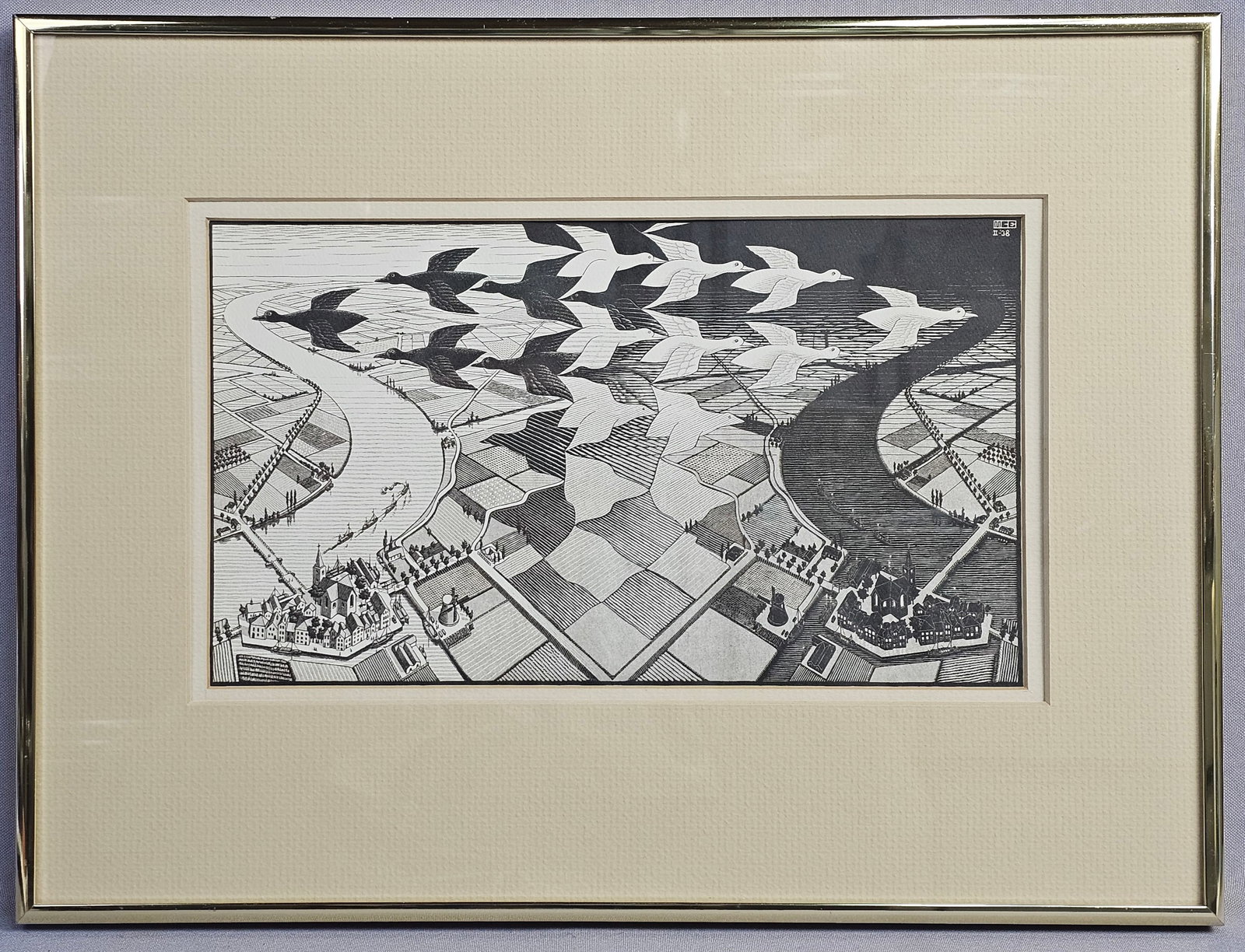M.C. Escher Day and Night Framed Art Print: This framed art print is a reproduction of the 1938 woodcut titled Day and Night (Dag en Nacht) by the Dutch artist M.C. Escher. The composition features a characteristic Escher tessellation with blac