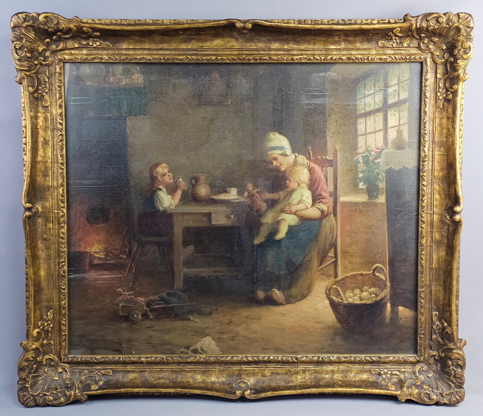 F.G. Grust Signed Oil on Canvas Dutch Interior Scene: This oil on canvas painting depicts a Dutch domestic genre scene, signed F.G. Grust in the lower right corner. The composition features a mother in traditional attire, including a white cap and blue
