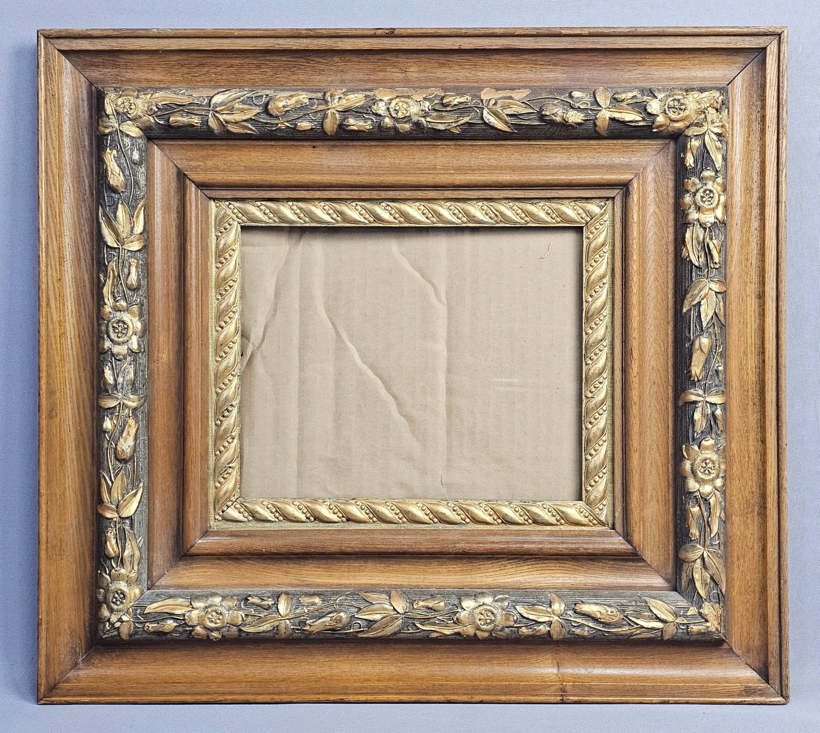 Victorian Style Tiered Oak & Gilded Composition Picture Frame: An ornate rectangular picture frame of tiered construction featuring an outer oak border with a deep cove profile. The intermediate band consists of gilded molded composition decorated with a