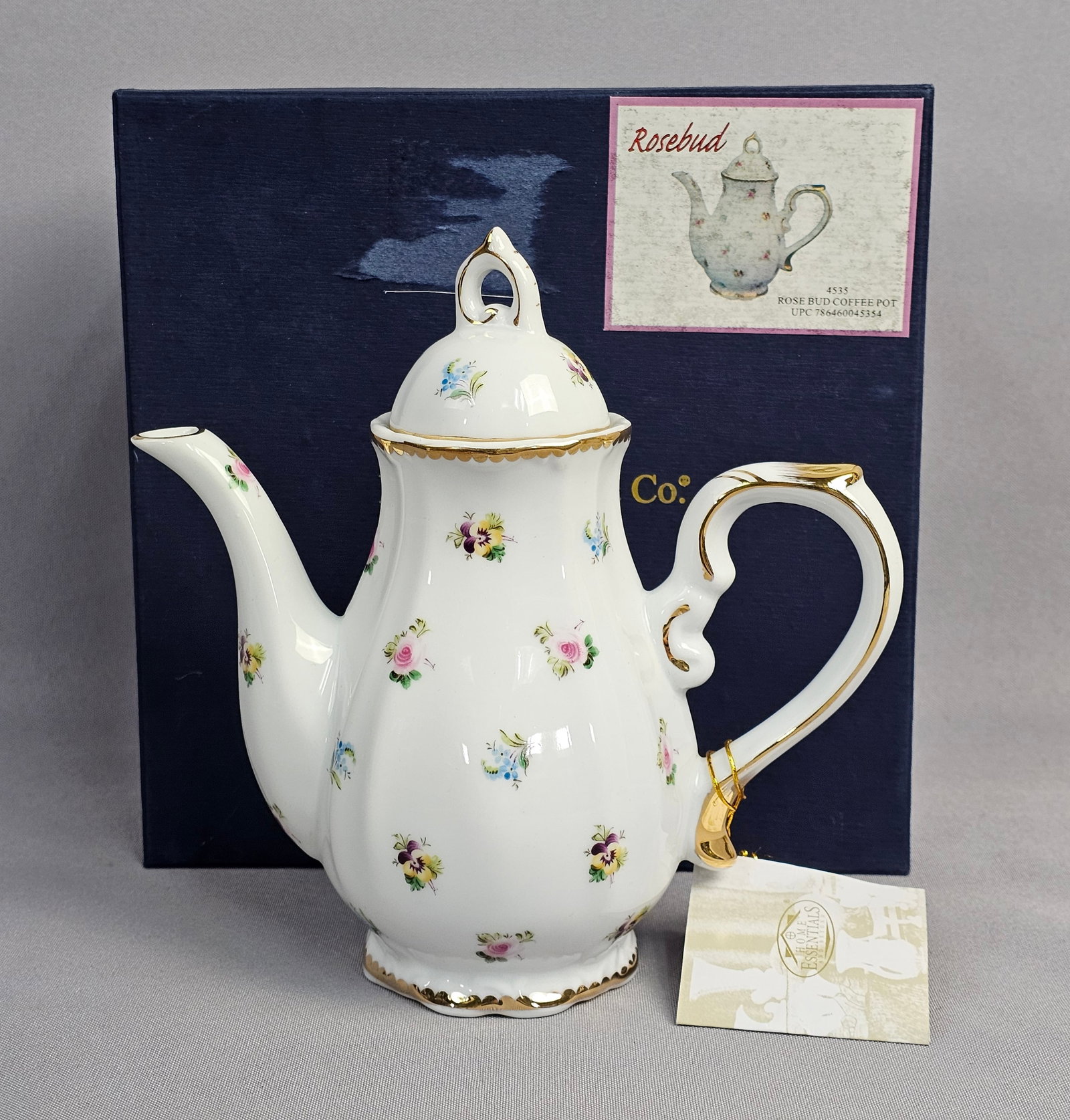I. Godinger and Co. Rosebud Pattern Porcelain Coffee Pot: This is a porcelain coffee pot produced by I. Godinger and Co. decorated in the Rosebud pattern. The vessel features a fluted, pear-shaped body made of white porcelain set upon a scalloped pedestal fo