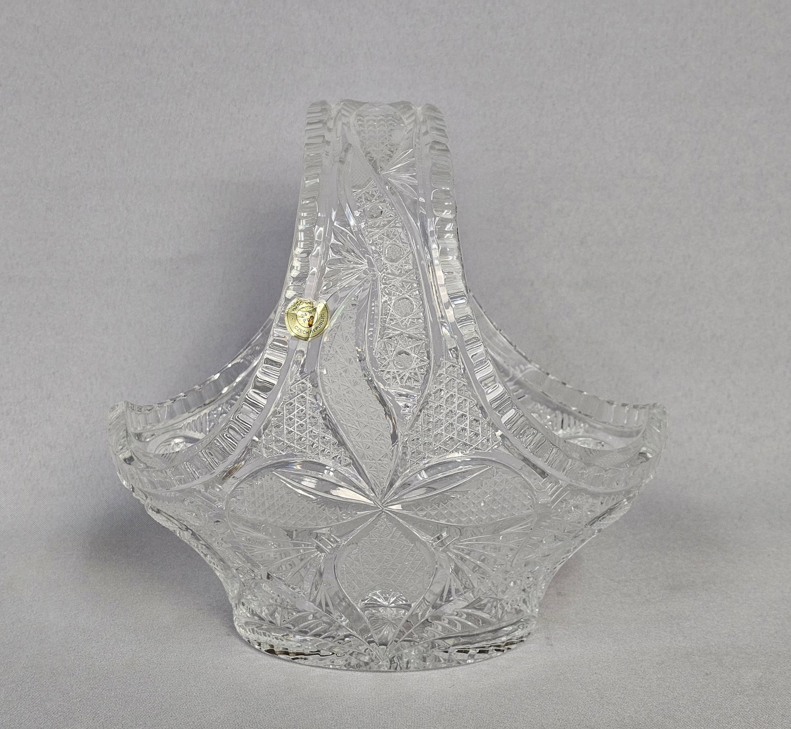 Czech 24% Lead Crystal Hand-Cut Handled Basket: This is a Bohemian lead crystal handled basket produced in the Czech Republic. The item is manufactured from 24% lead oxide crystal, which provides high clarity and significant light refraction. The