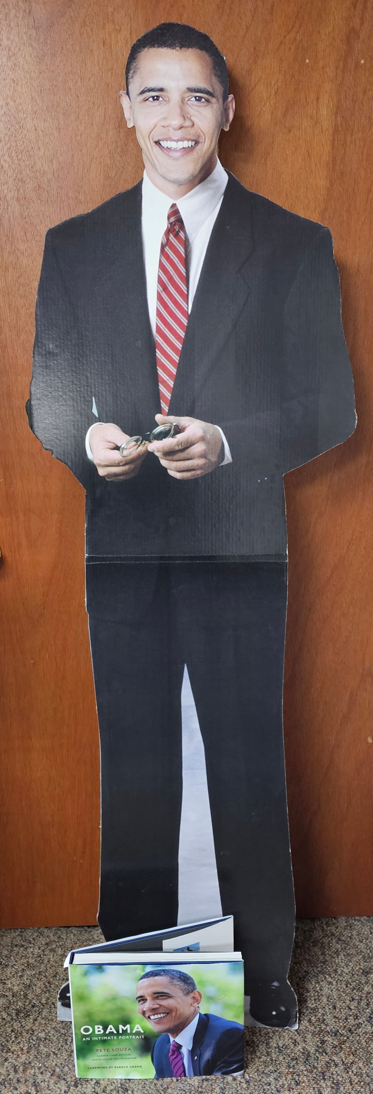 Barack Obama Life-Size Cardboard Standee & Book: This lot features two items of political memorabilia related to Barack Obama. The first item is a life-size cardboard standee. The second item is a hardcover photography book titled Obama: An