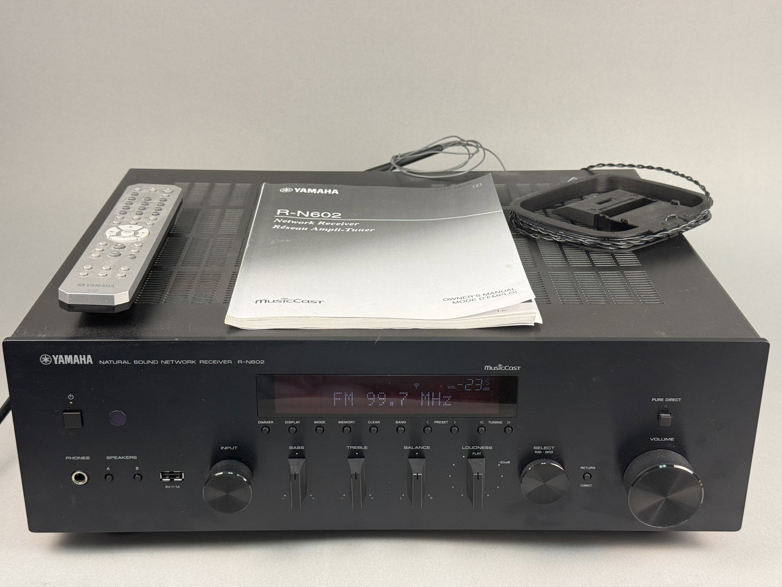 Yamaha R-N602 Natural Sound Network Receiver: This Yamaha R-N602 Natural Sound Network Receiver is a high-fidelity audio component featuring integrated MusicCast technology, Wi-Fi, and Bluetooth connectivity. The unit is finished in black and inc
