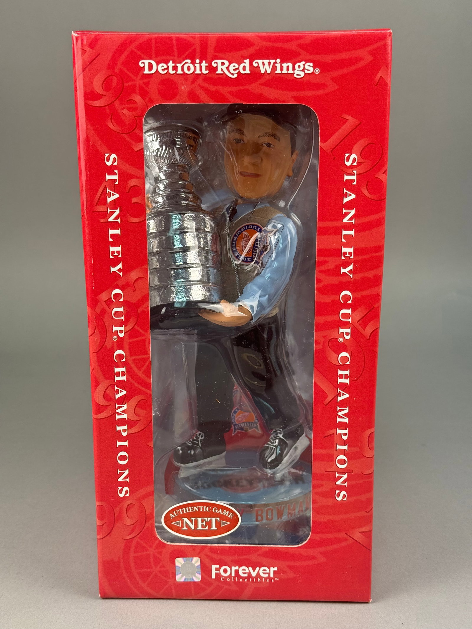 Scotty Bowman Detroit Red Wings 2002 Stanley Cup Bobblehead: The collectible commemorates the Detroit Red Wings 2002 Stanley Cup Championship. A unique feature of this collectible is the inclusion of an authentic piece of game-used net from Game 5 of the 2002