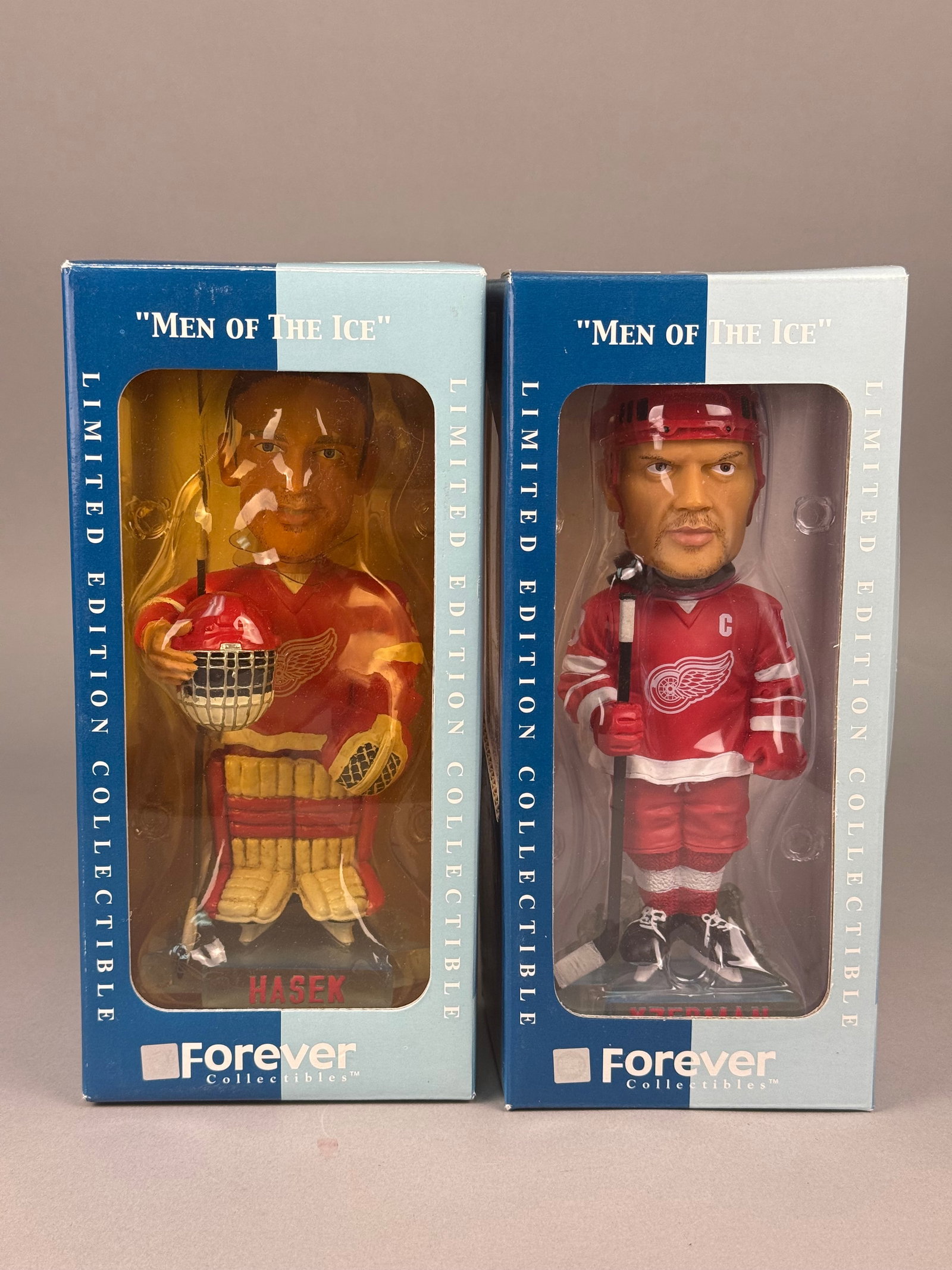 Detroit Red Wings Men of the Ice Limited Edition Bobbleheads: Both figurines are depicted in red Detroit Red Wings home jerseys. Each box displays official National Hockey League (NHL) and National Hockey League Players Association (NHLPA) licensed product