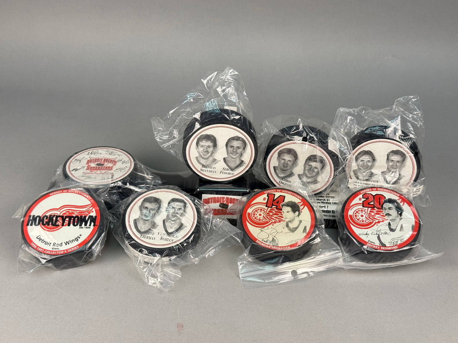 Detroit Red Wings Promotional Hockey Pucks & Stand: The lot features the complete five-puck Detroit Superstars FotoPucks series manufactured by FotoBall USA Inc. for Burger King in 1997. Players represented in this set include Brendan Shanahan, Sergei