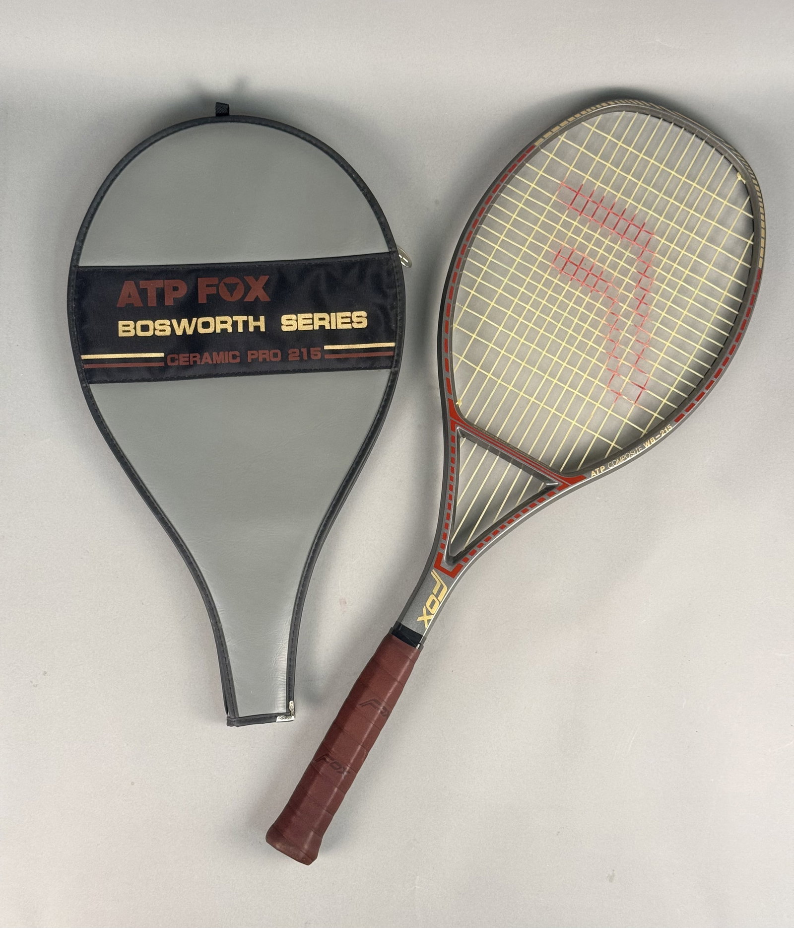 Vintage Fox Bosworth Signature Series ATP Composite WB-215 Tennis Racket: This is a vintage Fox tennis racket from the Bosworth Signature Series. The handle is wrapped in an original brown leather grip embossed with the Fox logo. The set includes a matching zippered gray