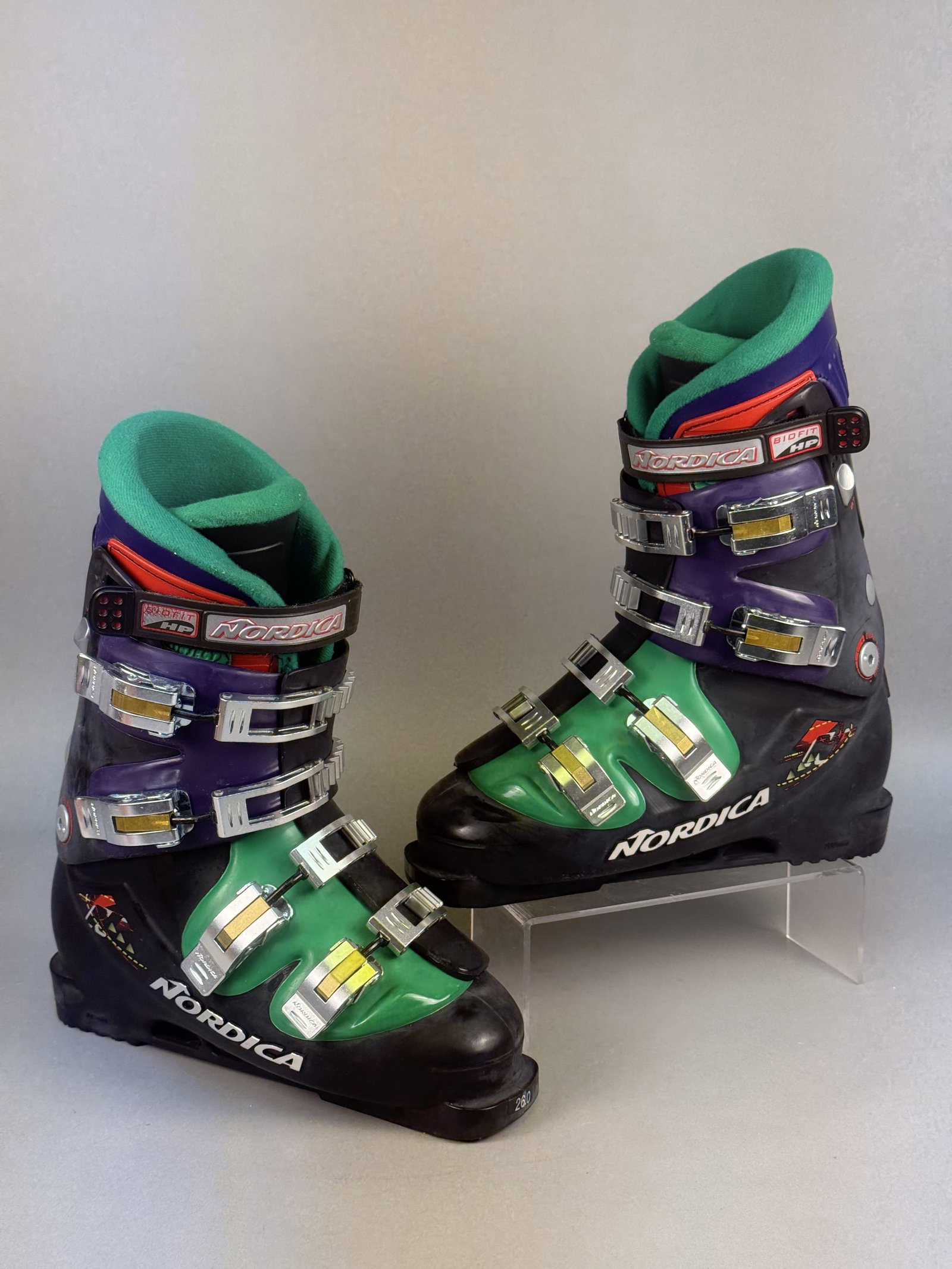 Vintage Nordica GPV Alpine Ski Boots Size 26.0: A pair of vintage Nordica GPV alpine ski boots, Mondopoint size 26.0, manufactured in Italy. Technical specifications include the Nordica Adjustable Power System (APS) with a flex index of 105 and