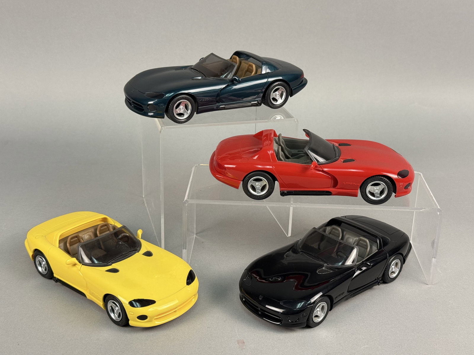 Four AMT ERTL 1/25 Scale Dodge Viper RT/10 Model Cars Original Boxes: A set of four die-cast model cars featuring the Dodge Viper RT/10, produced by AMT ERTL. The collection includes four distinct model years: a 1992 model in red (item number 6113), a 1993 model in blac