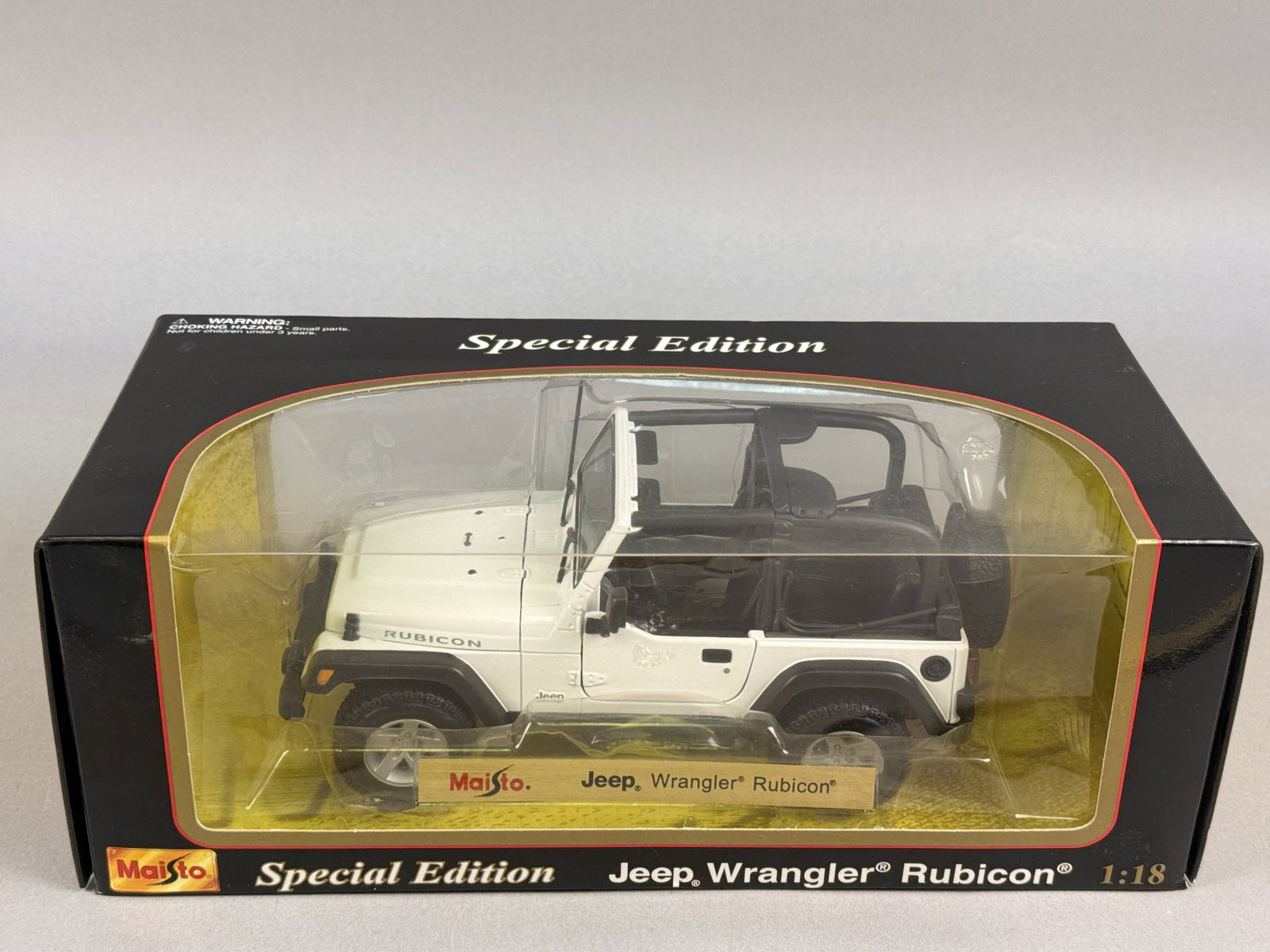 Maisto Special Edition 1:18 Scale Jeep Wrangler Rubicon: A 1:18 scale model vehicle of a Jeep Wrangler Rubicon, manufactured by Maisto as part of the Special Edition series. The item is contained in its original black window display box with a gold-tone int