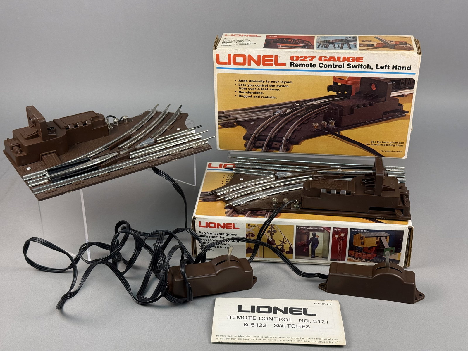 Lionel O27 Gauge No. 5121 Left Hand Remote Control Track Switches: This lot features a pair of Lionel O27 gauge model train accessories, specifically No. 5121 Left Hand remote control track switches from the Fundimensions era. Each switch consists of a brown textured