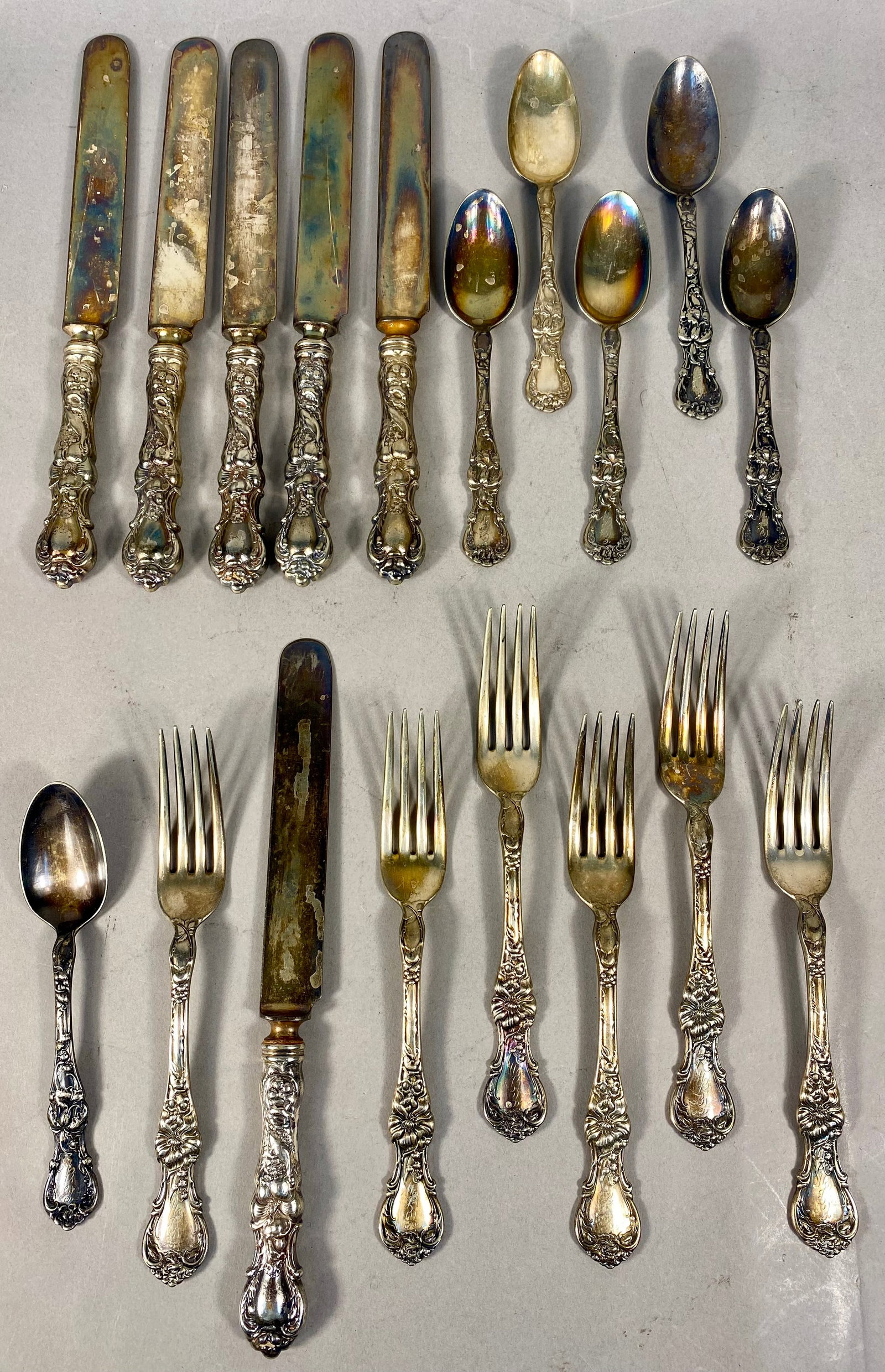 An 18-Piece Wallace Silversmiths Silver-Plated Flatware Service in the Rose Pattern: An 18-piece partial silver-plated flatware service by Wallace Silversmiths in the Rose pattern, first introduced in 1904. The service includes six dinner knives, six dinner forks, and six teaspoons.