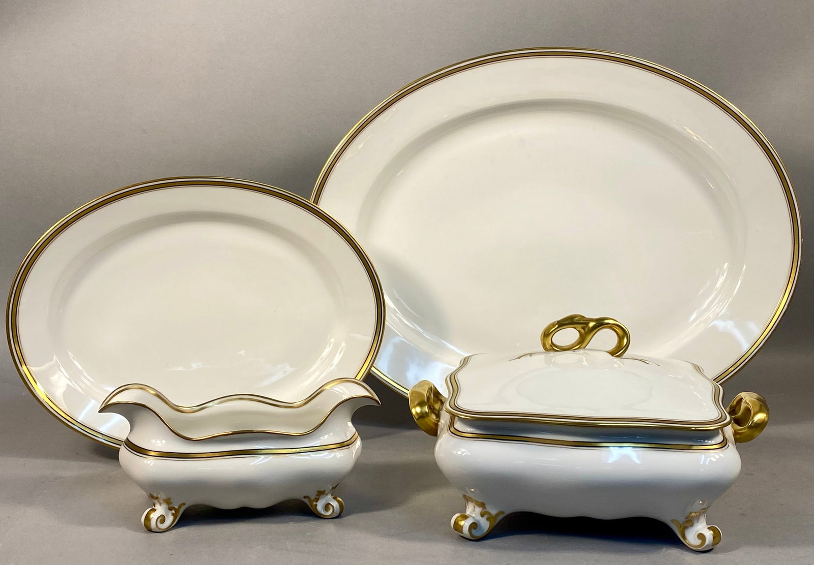 G.D.A. Limoges Porcelain Serving Ware in the Old Abbey Pattern: A five piece group of G.D.A. Limoges porcelain serving ware in the Old Abbey pattern. This set features a white ground decorated with a wide gilded rim and a secondary thin cobalt blue band. The