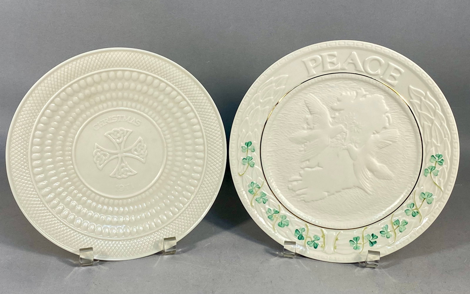 Two Belleek Parian Porcelain Collector Plates: This lot features two fine Parian porcelain collector plates manufactured by Belleek Pottery in County Fermanagh, Ireland. The first item is a limited edition 1971 Christmas plate. The center is relie