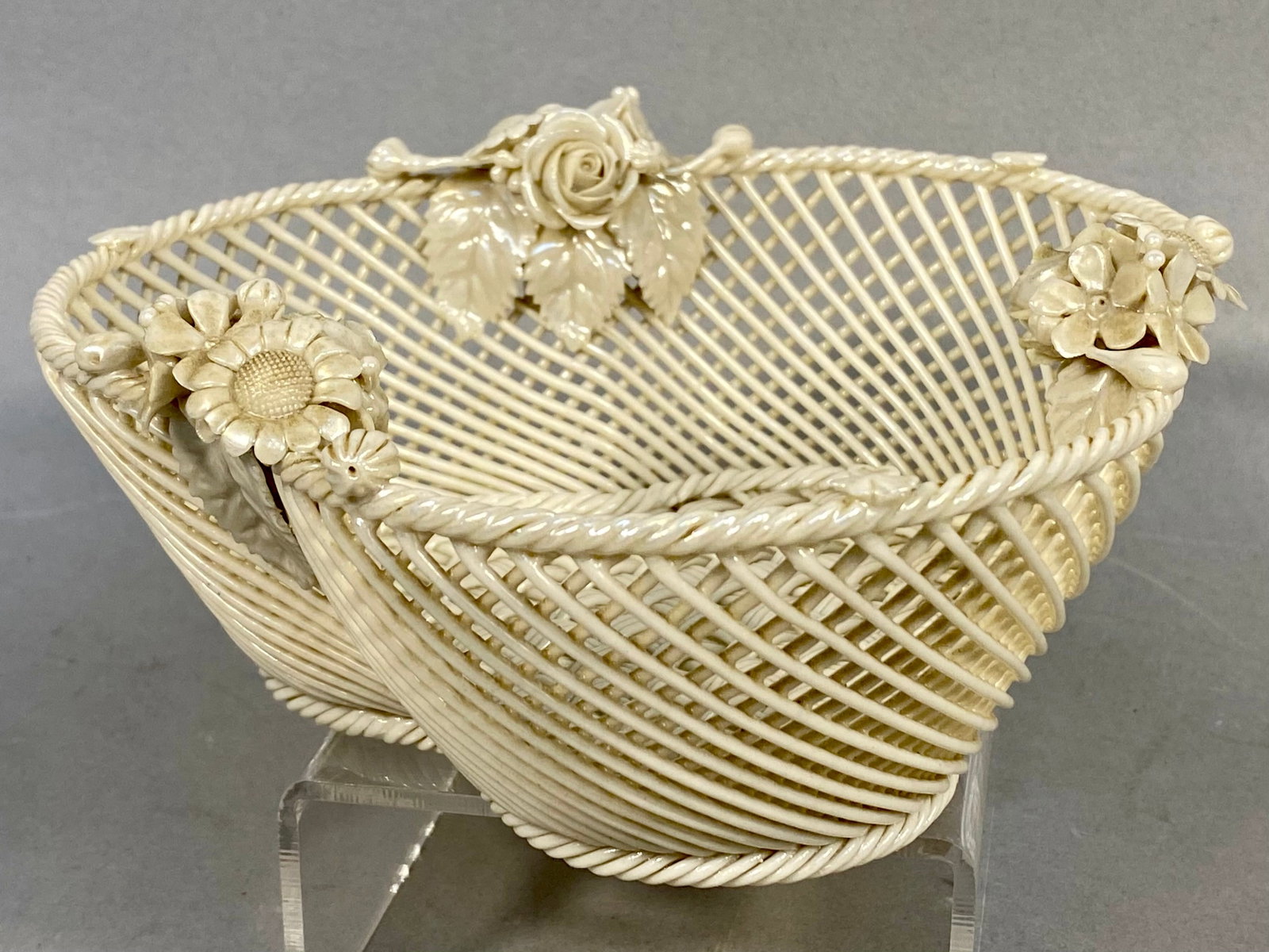 Belleek Irish Trilobed Woven Parian Porcelain Basket: An Irish Belleek parian porcelain woven basket of trilobed or trefoil form. The vessel is constructed with intricate, hand-woven ceramic strands in a lattice pattern. The upper rim and foot are