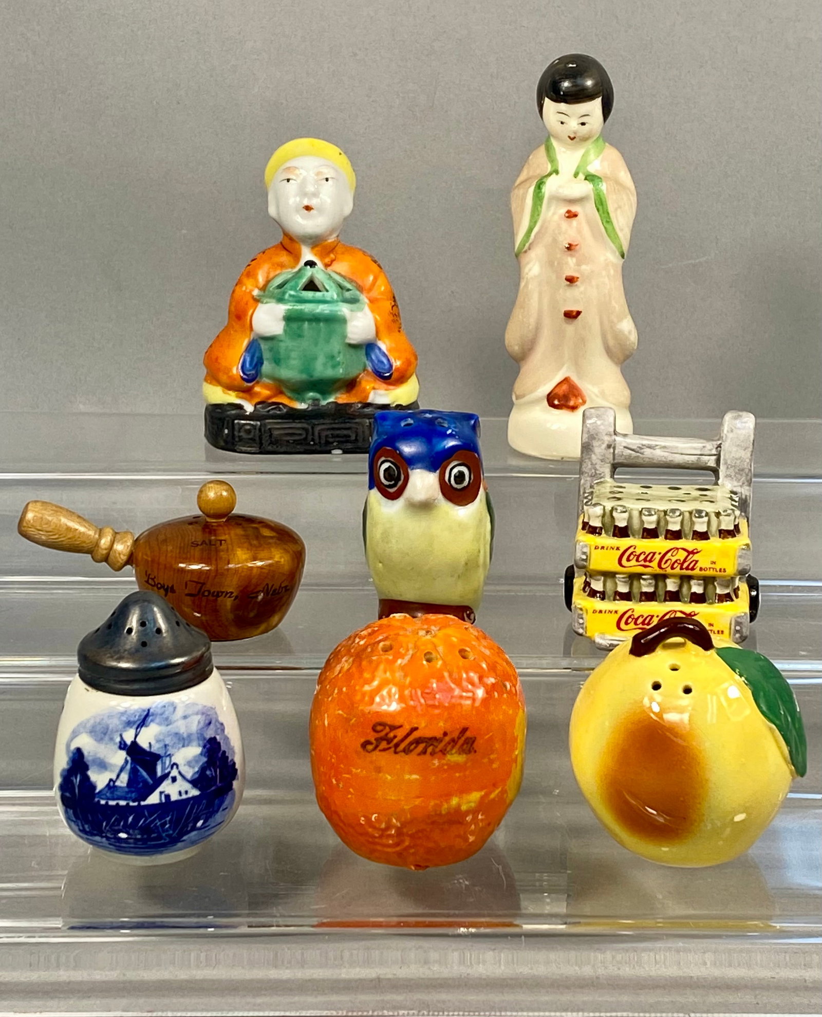 Eight Vintage Souvenir and Novelty Salt & Pepper Shakers: This collection consists of eight vintage souvenir and novelty items including salt and pepper shakers and small figurines crafted from ceramic, wood, and metal. The assortment features a Delft-style