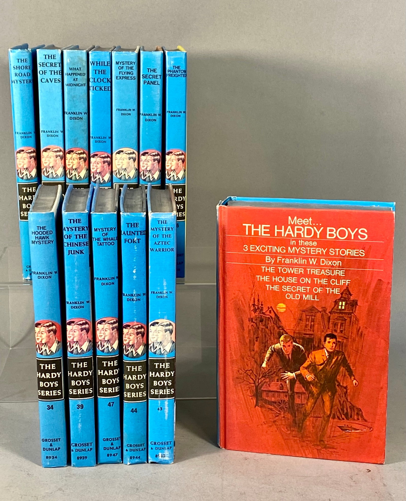 A Collection of 13 Hardy Boys Mystery Stories: A collection of 13 hardcover volumes from The Hardy Boys Mystery Stories series by Franklin W. Dixon, published by Grosset & Dunlap. The group includes a triple-feature omnibus volume titled Meet...