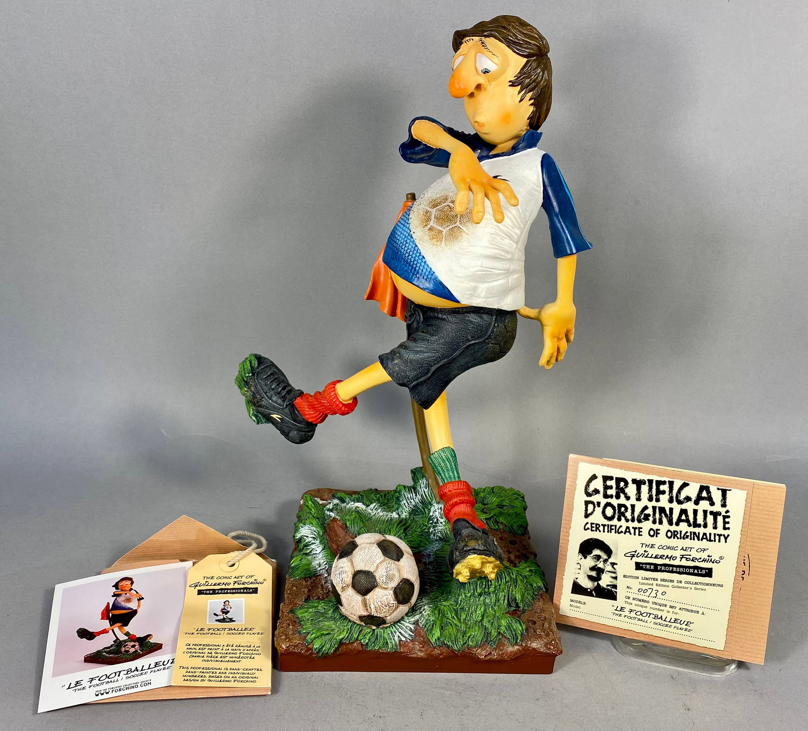 Guillermo Forchino Le Footballeur Large Hand-Painted Resin Sculpture: This large-scale, hand-painted resin sculpture titled Le Footballeur (The Footballer / Soccer Player) is part of The Professionals series by artist Guillermo Forchino. The piece depicts a middle-aged
