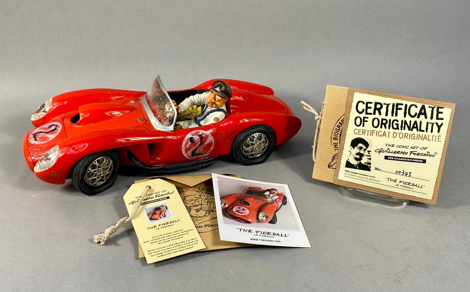 Guillermo Forchino The Fireball Comic Art Sculpture No. 00345: A hand-painted polyresin comic art sculpture titled The Fireball (Le Fireball) by artist Guillermo Forchino. The piece depicts a stylized vintage red open-top racing car featuring pontoon fenders and