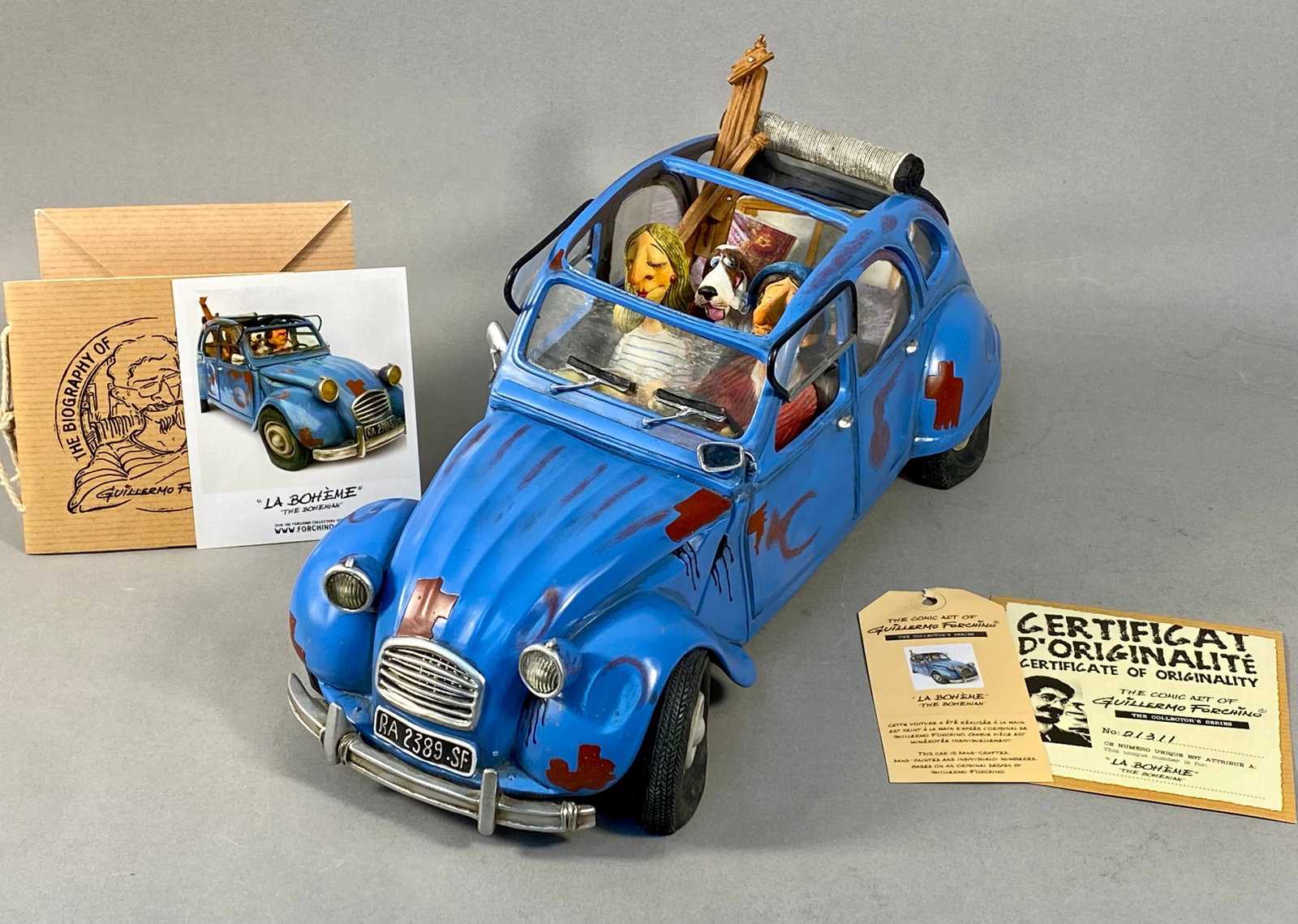 Guillermo Forchino La Boheme The Bohemian Comic Art Sculpture No. 01311: A hand-painted cold-cast resin comic art sculpture titled La Boheme or The Bohemian from The Comic Art of Guillermo Forchino Collector's Series. The piece depicts a blue Citroen 2CV automobile