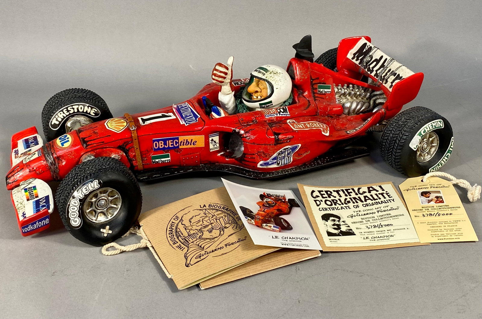 Guillermo Forchino The Champion Limited Edition Comic Art Sculpture: A large-scale comic art sculpture titled Le Champion (The Champion) from The Comic Art of Guillermo Forchino collection, produced by Veronese. This piece depicts an exaggerated Formula 1 racing car