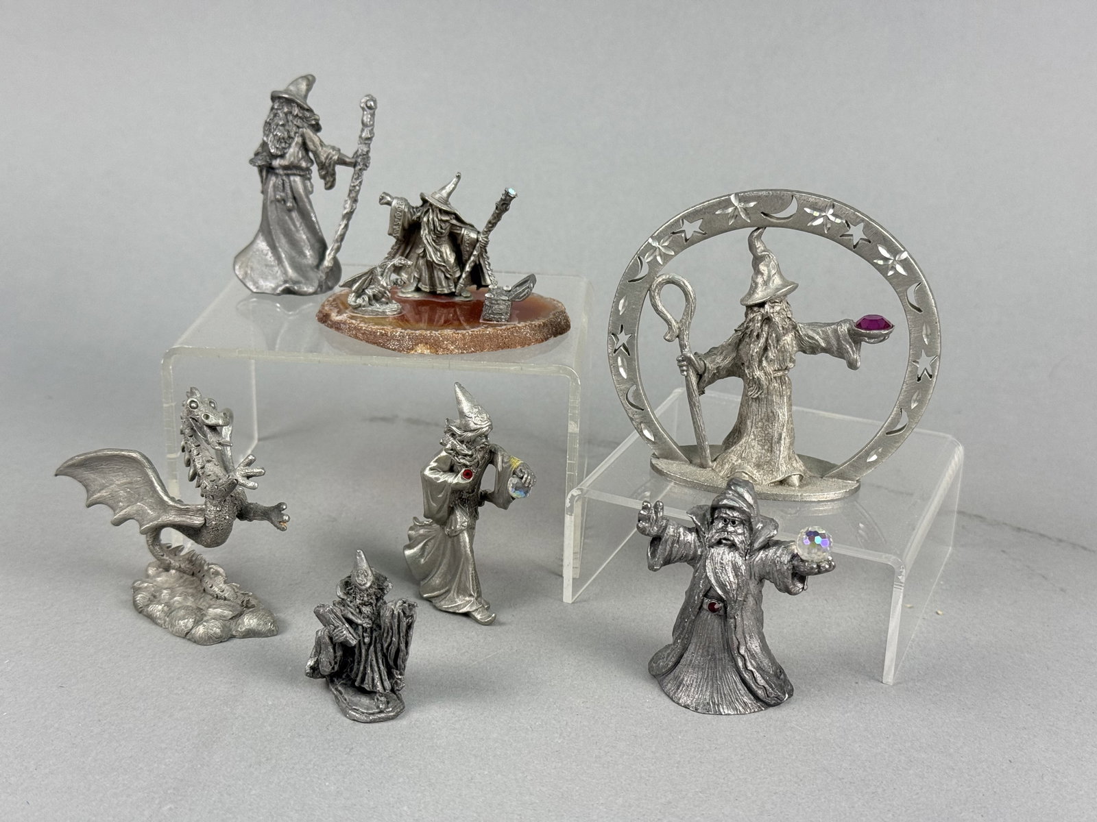 Vintage Spoontiques Pewter Wizard and Dragon Figurines: cast pewter fantasy-themed figurines manufactured by Spoontiques. The base of the celestial wizard is marked with the copyright for Spoontiques, the model number MR828, and PEWTER. The standalone