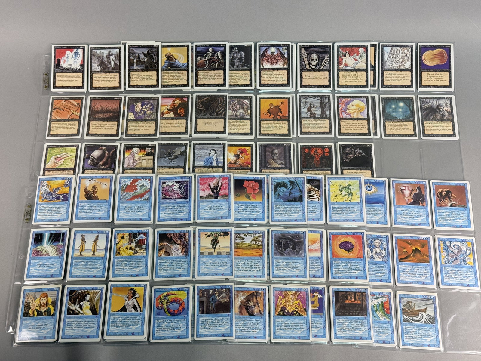Magic The Gathering Revised Blue and Black Cards: This lot features a collection of Magic: The Gathering (MTG) trading cards from the Revised Edition. Lot consists of Black and Blue cards. There are multiples (up to 4) of some cards. Binder page