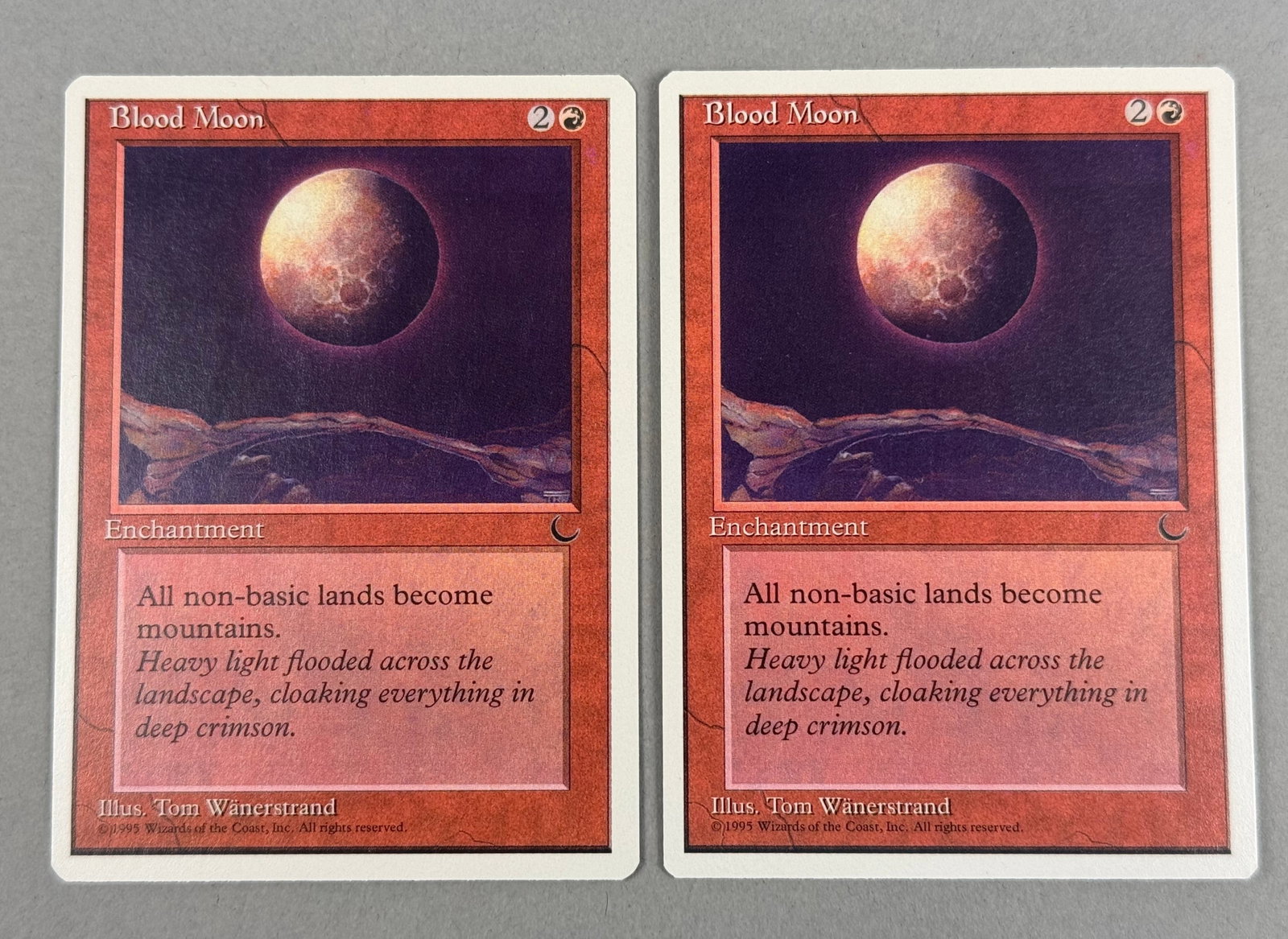 Magic The Gathering Chronicles Blood Moon Cards: This lot consists of two original Magic: The Gathering trading cards featuring Blood Moon from the Chronicles expansion, released in 1995. The bottom edge includes the illustrator credit and the