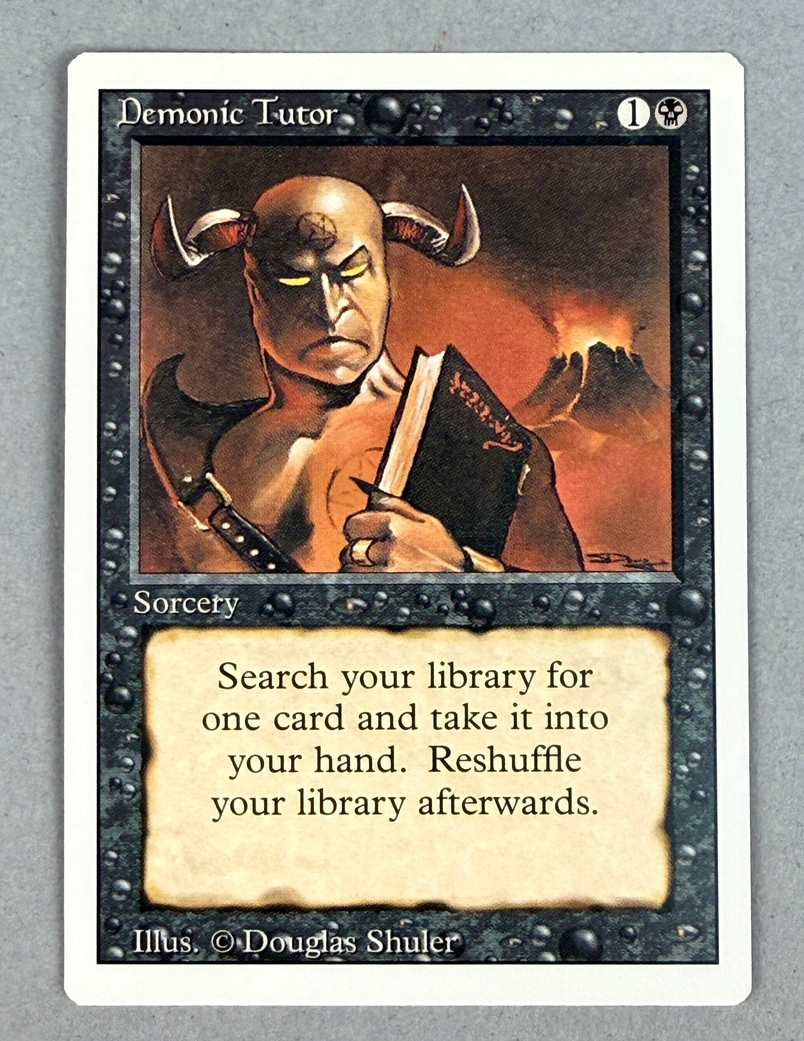Magic The Gathering Revised Demonic Tutor: This is a single Magic: The Gathering trading card, Demonic Tutor, from the Revised Edition. The card is a black Sorcery and features artwork by Douglas Shuler. T Width: 2.5 inches Height: 3.5 inches 