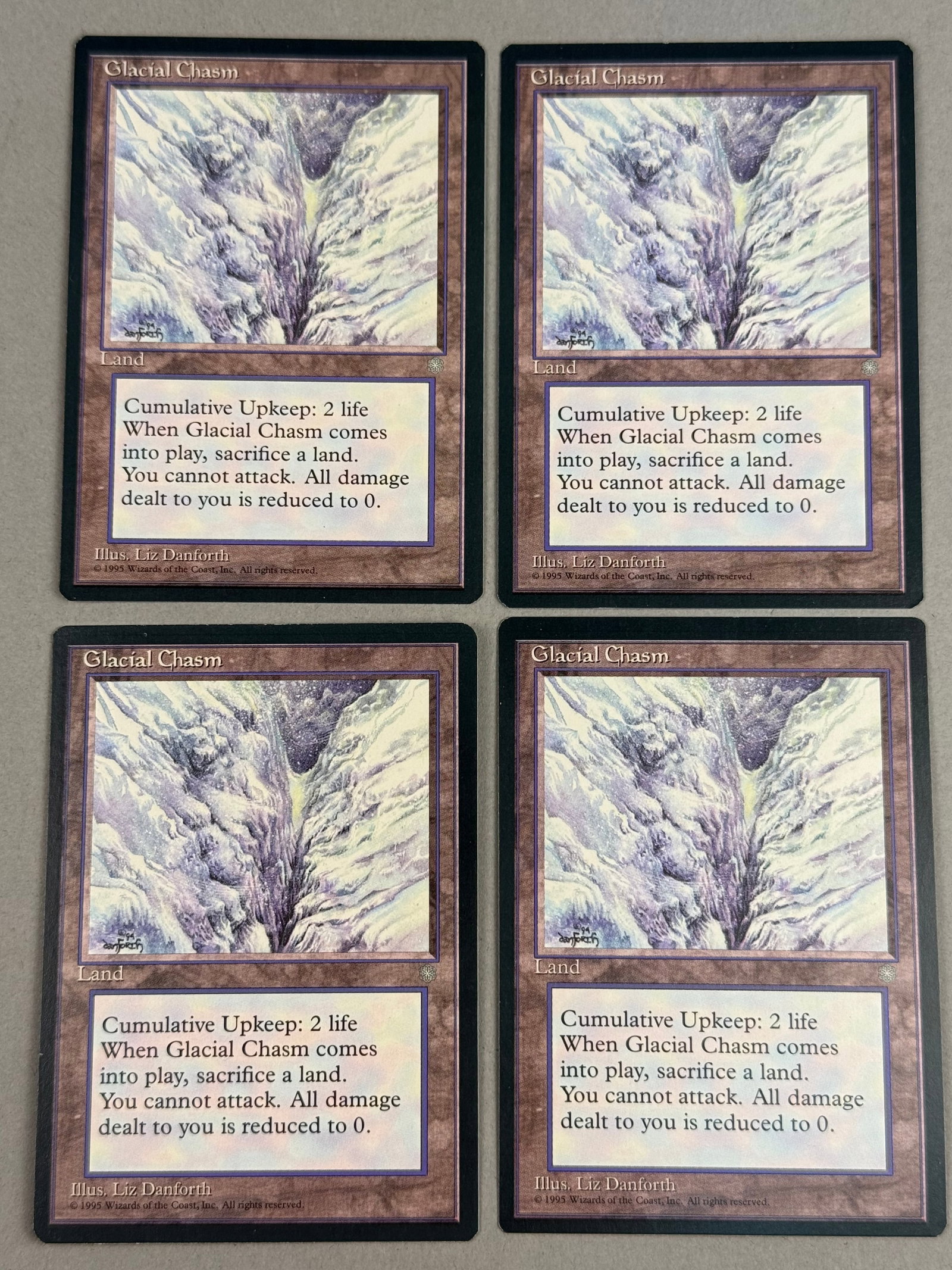 4 Magic The Gathering Ice Age Glacial Chasm: A set of four Magic: The Gathering trading cards featuring the card Glacial Chasm from the Ice Age expansion, released in 1995. The copyright information at the bottom of each card reads Illus. Liz